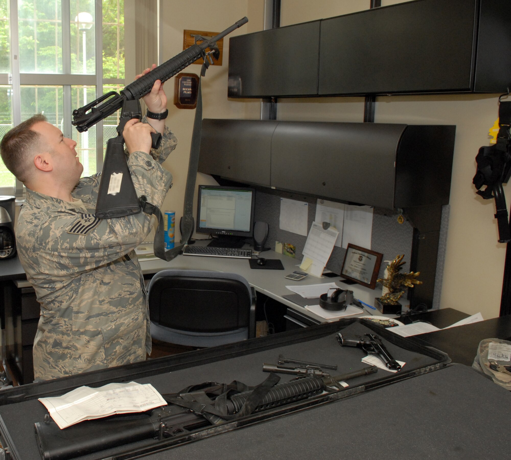 MISAWA AIR BASE, Japan -- Tech. Sgt. Robert Slagle, 35th Security Forces Squadron combat arms NCO in charge, performs a pre-deployment inspection on an M-16A2 rifle Jun. 9 at the Combat Arms building. Air Force combat arms used to be known as combat arms training and maintenance. (Air Force photo/Staff Sgt. Phillip Butterfield)