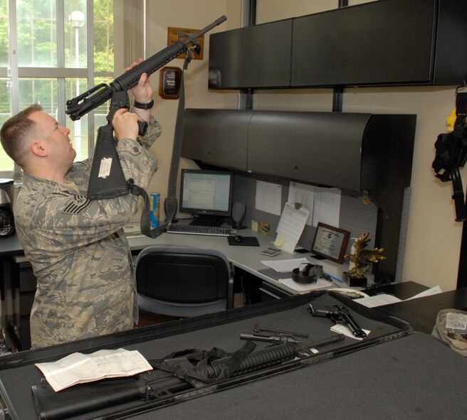 MISAWA AIR BASE, Japan -- Tech. Sgt. Robert Slagle, 35th Security Forces Squadron combat arms NCO in charge, performs a pre-deployment inspection on an M-16A2 rifle Jun. 9 at the Combat Arms building. Air Force combat arms used to be known as combat arms training and maintenance. (Air Force photo/Staff Sgt. Phillip Butterfield)