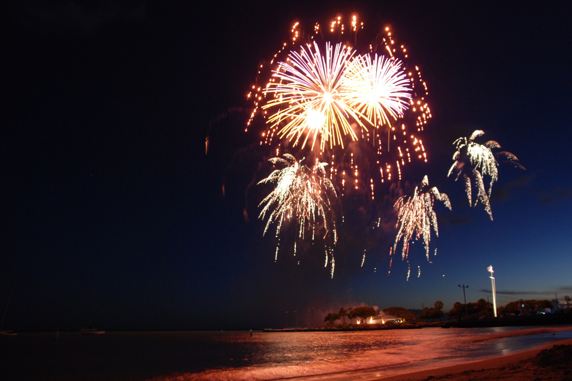 HICKAM AIR FORCE BASE, Hawaii -- Fireworks explode over Hickam Harbor during the grand finale of the All American Beach Blast July 4. The All American Beach Blast, hosted by 15th Services Squadron, began with camping and a movie under the stars July 3. The celebration continued July 4 with food booths, live entertainment, a kiddieland play area, bounce houses, swimming, as well as powerboat, sailboat and banana boat rides in the harbor. (U.S. Air Force photo/Staff Sgt. Mike Meares)