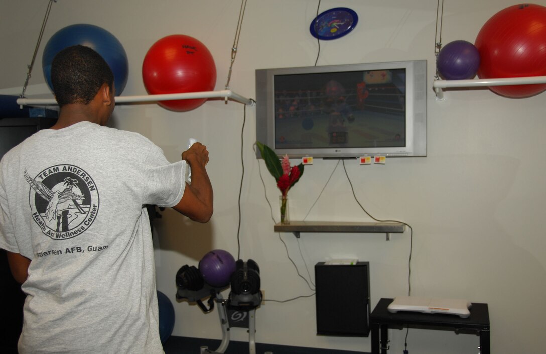ANDERSEN AIR FORCE BASE, Guam - Jordan Walker, a summer hire for the physical therapy clinic, goes through a mock "Wii-hab" warmup here July 1. The Wii-hab concept is part of an initiative within the clinic to find innovative ways to make rehabilitation fun for patients. (U.S. Air Force photo by Senior Airman Shane Dunaway)