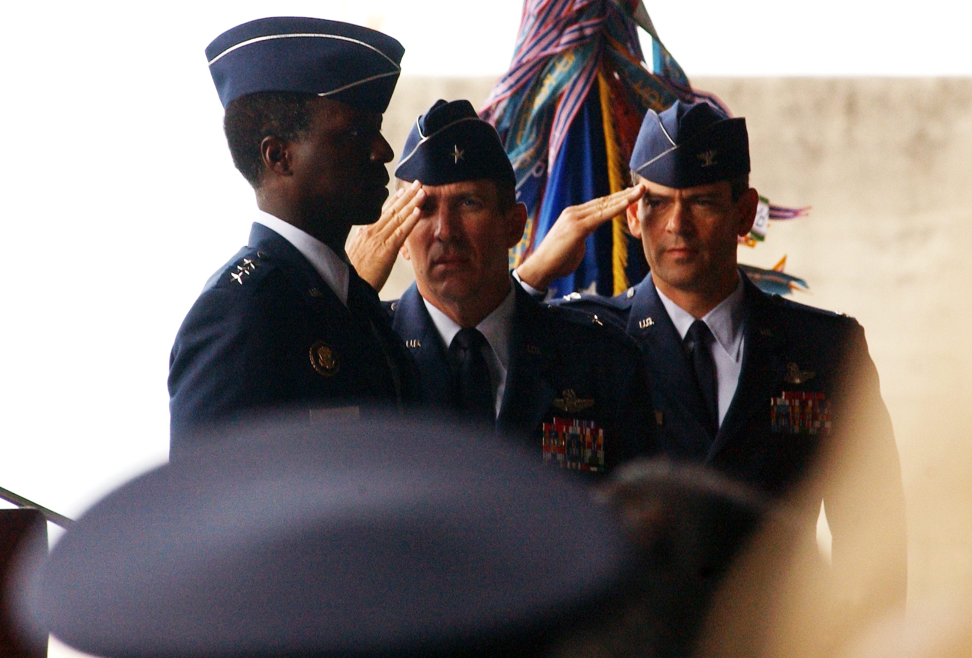 Gen. Brett Williams and Col. Kenneth Wilsbach salute Lt. Gen. Edward Rice, commander of U.S. Forces Japan and 5th Air Force, during  the 18th Wing change of command July 9 at Kadena Air Base, Japan. (U.S. Air Force photo/Tech. Sgt. Rey Ramon)   