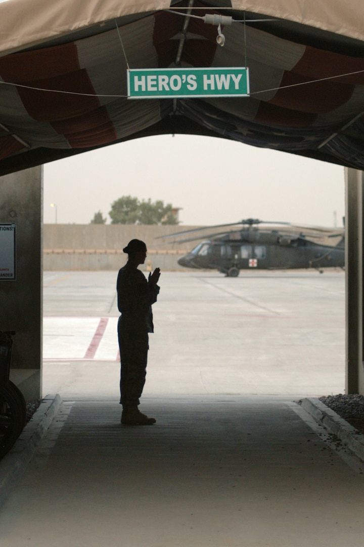 JOINT BASE BALAD, Iraq -- Army Sgt. Jennifer Watson, NCO-in-charge of the Casualty Liaison Team here, stands in Hero's Highway. Each patient brought via helicopter to the Air Force Theater Hospital passes through Hero's Highway. Sergeant Watson, a native of Peru, Ind., is deployed here from Fort Campbell, Ky. (U.S. Air Force photo/Staff Sgt. Dilia Ayala)