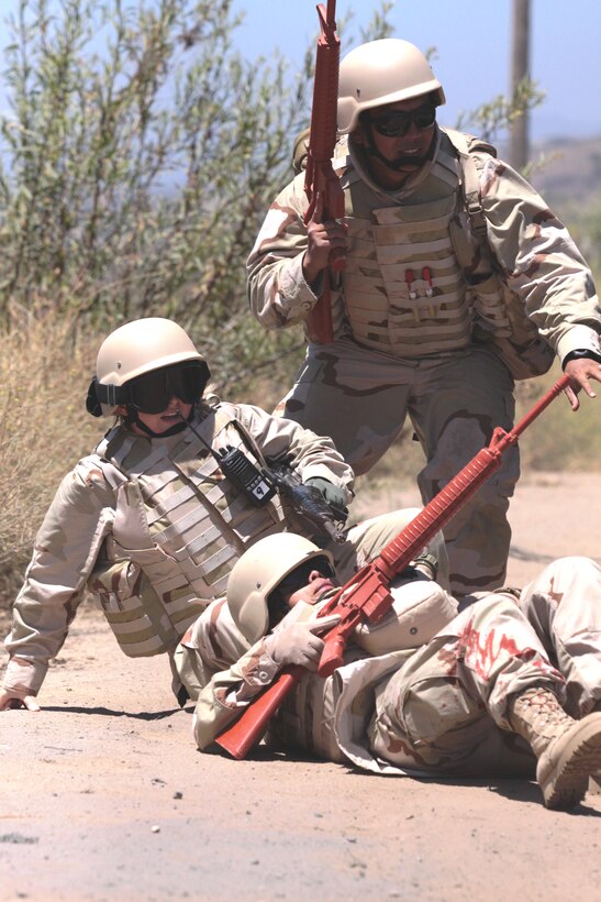 Top to bottom) Chief Petty Officer 2nd Class Jayson Rosa, corpsman, Expeditionary Medical Facility Kuwait, Navy Lt. J.G. Joy Smart, trauma nurse, EMF Djbouti and Chief Petty Officer 2nd Class  Lisa T. Gomez, corpsman, EMF Kuwait pull themselves out of a simulated improvise explosive device explosion during the Navy Expeditionary Medical Training Institute field training exercise, July 9.::r::::n::