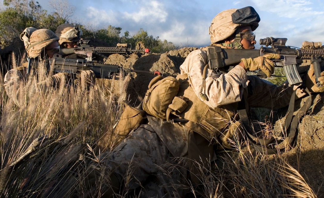 Marines of 1st Platoon, Bravo Company, 1st Battalion, 3rd Marine Regiment, fire blank ammunition as supporting fire while fellow Marines move closer to better positions during an attack on a simulated enemy compound.