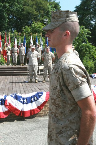 Maj. Stan Bacon (back right), operations officer, Headquarters and Service Company, Chemical Biological Incident Response Force, II Marine Expeditionary Force, looks at his son, Lance Cpl. Bradley Cox (forefront), an F/A-18 Super Hornet power line mechanic with Marine Fighter Attack Squadron (All-Weather) 224, Marine Corps Air Station Beaufort, S.C., as he participates in his father’s retirement ceremony aboard Naval Support Facility Indian Head, Md., July 9, 2009.