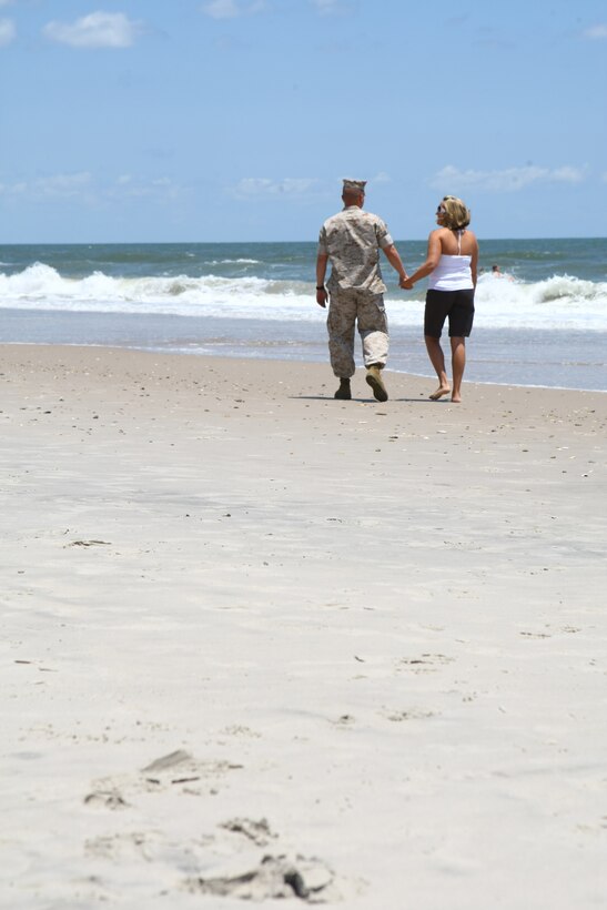 Gunnery Sgt. Michael Reiser and his wife Carri embrace aboard Onslow Beach July 10. The couple, who have been married 11 years and have two daughters, recently completed Camp Lejeune's Fireproof Marriage Enrichment Program.