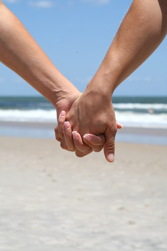 Gunnery Sgt. Michael Reiser and his wife Carri embrace aboard Onslow Beach July 10. The couple, who have been married 11 years and have two daughters, recently completed Camp Lejeune's Fireproof Marriage Enrichment Program.