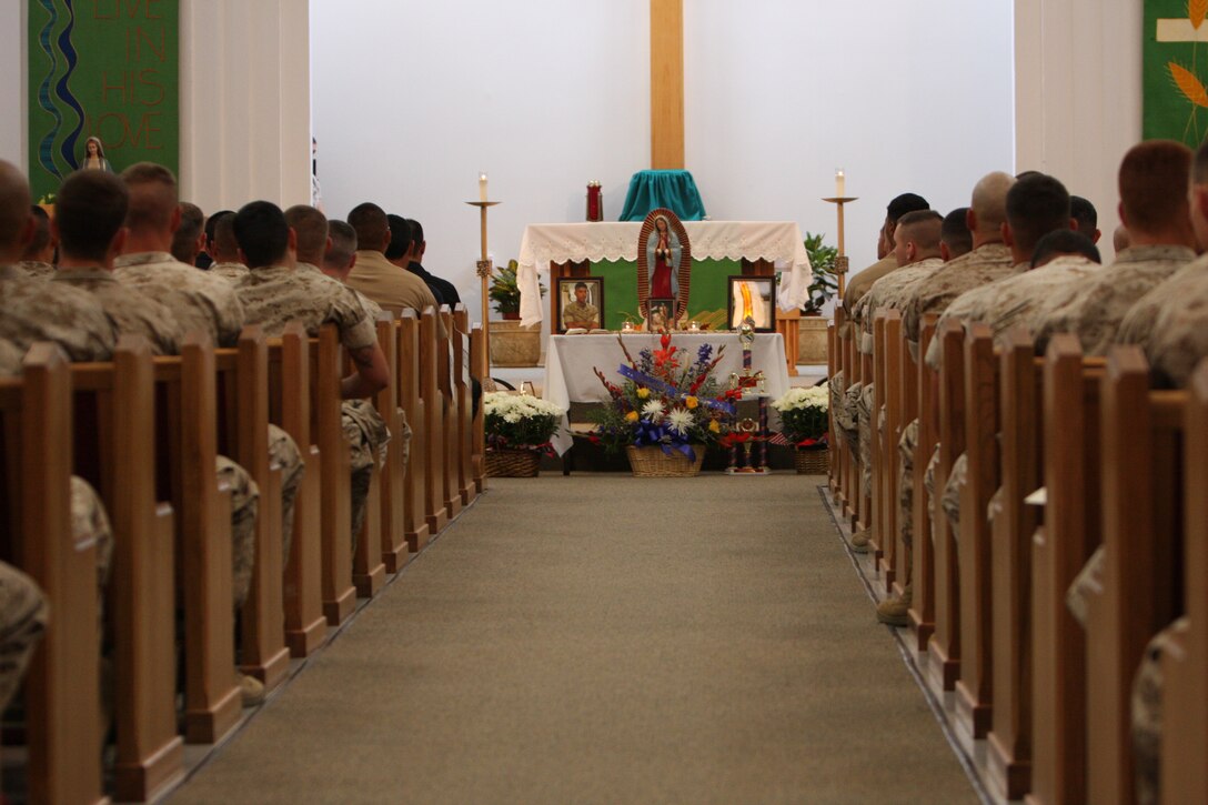 Memorabilia and photos are displayed of Lance Cpl. Julio Galvan, a 21-year-old automotive diesel mechanic with 3rd Combat Engineer Battalion and Maywood, Ill., native, and Pfc. Isidro Godinez, a 19-year-old automotive diesel mechanic with 3rd CEB and a Calexico, Calif., native, in the Combat Center’s Catholic Chapel July 10 during the battalion’s memorial service for their brothers who lost their lives over the Fourth of July weekend.