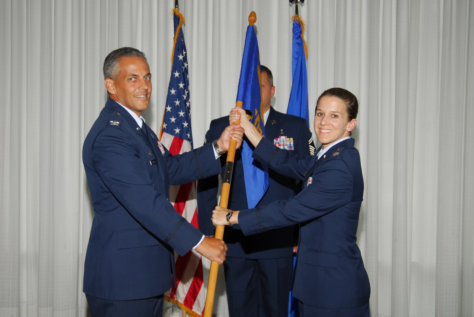 (Left) Col. Gino Auteri 325th Medical Group commander, presents the guidon to Lt. Col. Shari Silverman, as she takes command of the 325th Medical Support Squadron. The change of command ceremony took place July 10 at the Heritage Club. (U.S. Air Force photo/Lisa Norman)