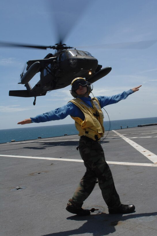 CORINTO, Nicaragua — Aviation Boatswain's Mate 3rd Class Matthew Shaw directs a UH-60 Army Blackhawk helicopter performing Deck Landing Qualifications aboard hospital ship USNS Comfort here July 9 during Continuing Promise 2009 (CP09).  The helicopter is assigned to Joint Task Force Bravo, U.S. Southern Command's forward-deployed response force stationed in Soto Cano AFB, Honduras, and is assisting CP09 teams with personnel movement and logistics here.  CP09 combines U.S. military and interagency personnel, non-governmental organizations, civil service mariners, academic and partner nations to provide medical, dental, veterinary and engineering services afloat and ashore alongside host nation personnel.  (U.S. Air Force photo by Senior Airman Jessica Snow)