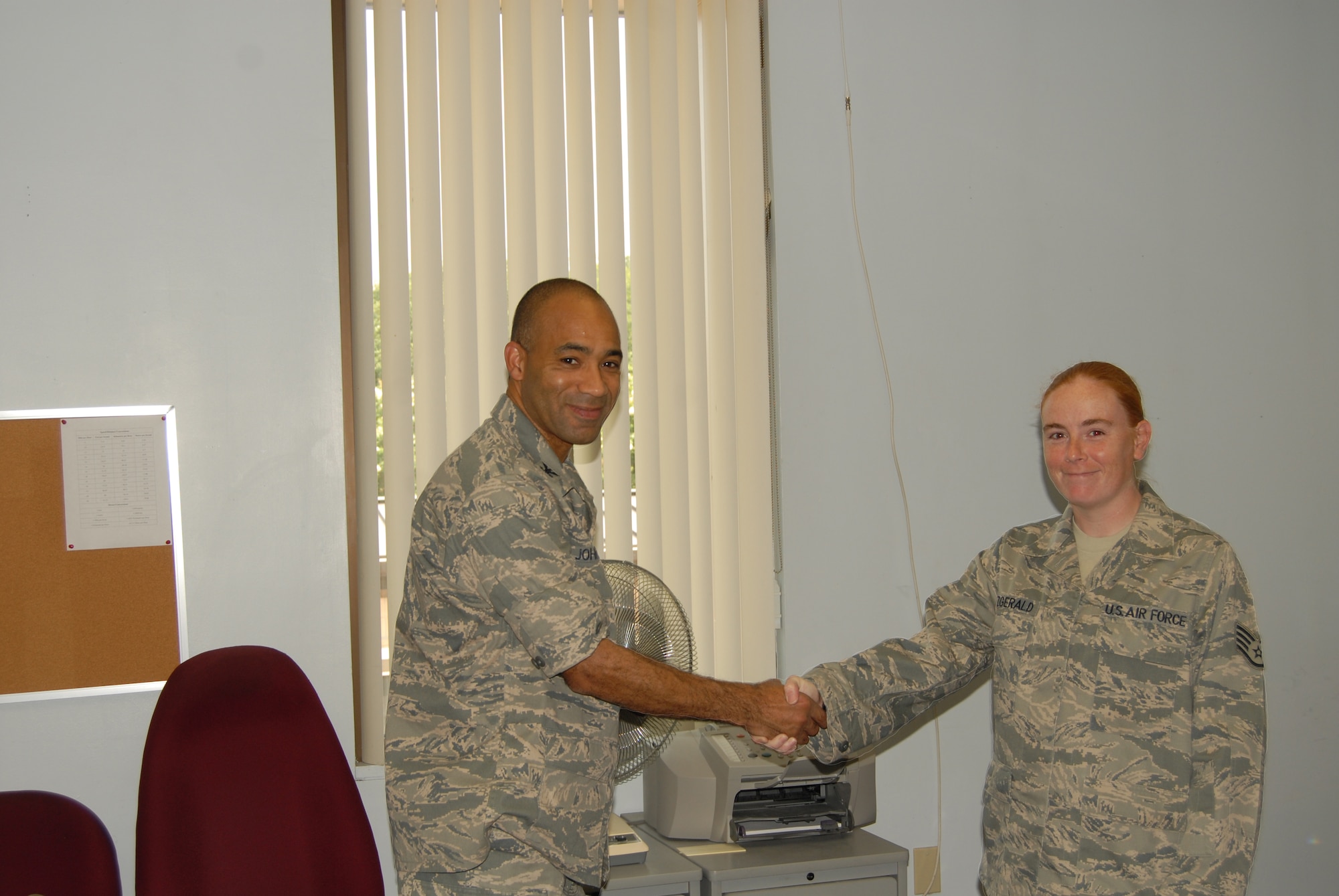Col. James Johnson, 43rd Airlift Wing Commander, presents a Commander’s Coin to Staff Sgt. Krista Fitzgerald, 43rd Airlift Wing, June 7. Sergeant Fitzgerald took charge of the recent Level II Antiterrorism certification course hosted by Pope.(U.S. Photo by Rhonda Griffin)