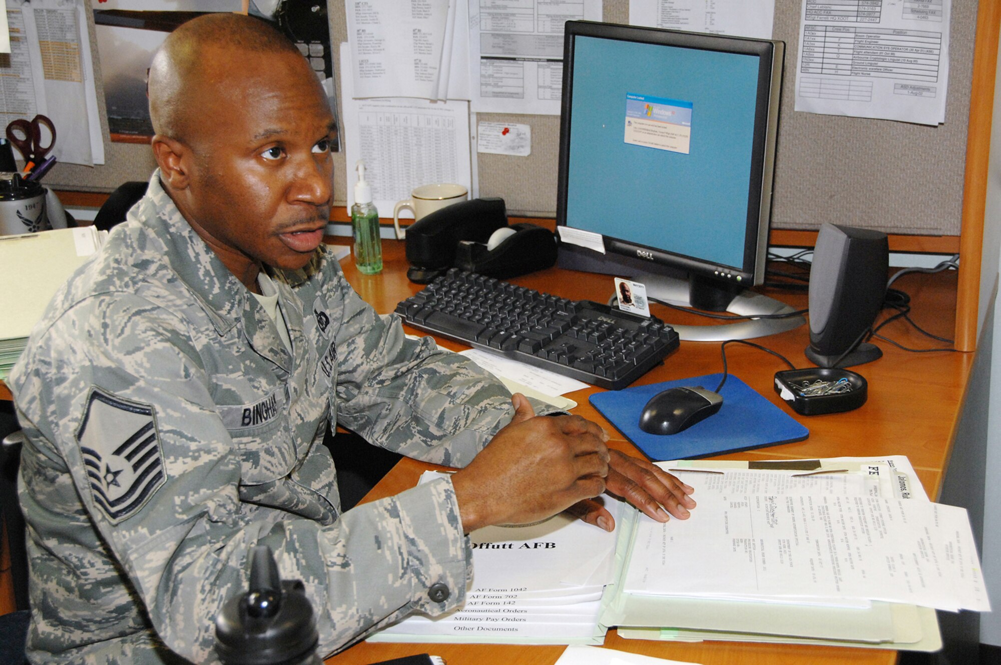 OFFUTT AIR FORCE BASE, Neb. -- Master Sgt. Tyrone F. Bingham, host aviation resource manager for the 170th Operational Support Squadron, explains how air crew records are maintained in his office here July 9. Sergeant Bingham is responsible for ensuring 1,700 records are properly accounted for on a daily basis. He was also recently selected as one of the Air Force's 12 Outstanding Airmen of the Year for 2009. U.S. Air Force Photo by Dana Heard