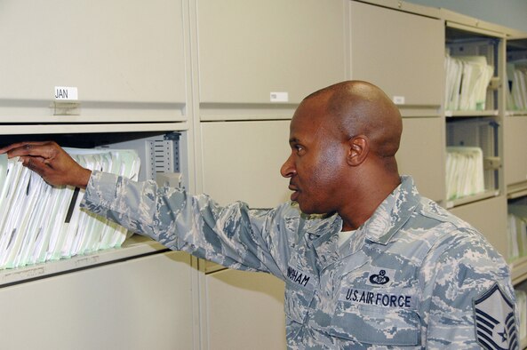 OFFUTT AIR FORCE BASE, Neb. -- Master Sgt. Tyrone F. Bingham, host aviation resource manager for the 170th Operational Support Squadron, searches for records to inspect in the 170th OSS Flight Records Office here July 9. Sergeant Bingham is responsible for ensuring 1,700 records are properly accounted for on a daily basis. He was also recently selected as one of the Air Force's 12 Outstanding Airmen of the Year for 2009. U.S. Air Force Photo by Dana Heard