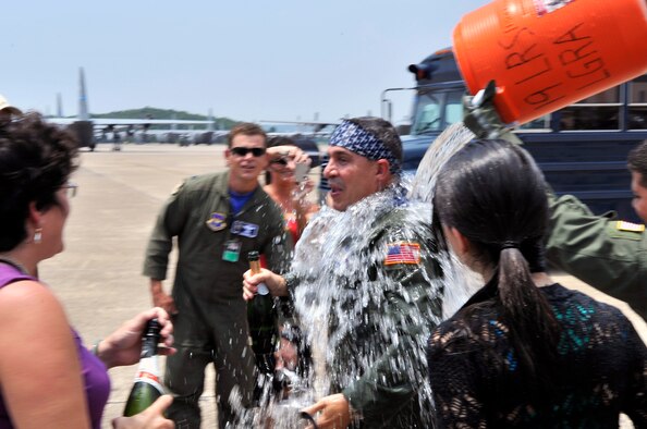 Col. Mark Vlahos, 314th Airlift Wing vice commander, is doused by friends and family members at his final flight at Little Rock Air Force Base July 10. The colonel’s next assignment is at Randolph AFB, Texas where he will serve as the 19th Air Force assistant director of operations. The colonel has served as the 314 AW’s vice commander since July 2007. The 314 AW’s mission is to train C-130 aircrews for all services in the Department of Defense, Coast Guard and 34 allied nations, as well as C-21 aircrew through the 45th Airlift Squadron at Keesler AFB, Miss. (U.S. Air Force photo by Staff Sgt. Chris Willis)