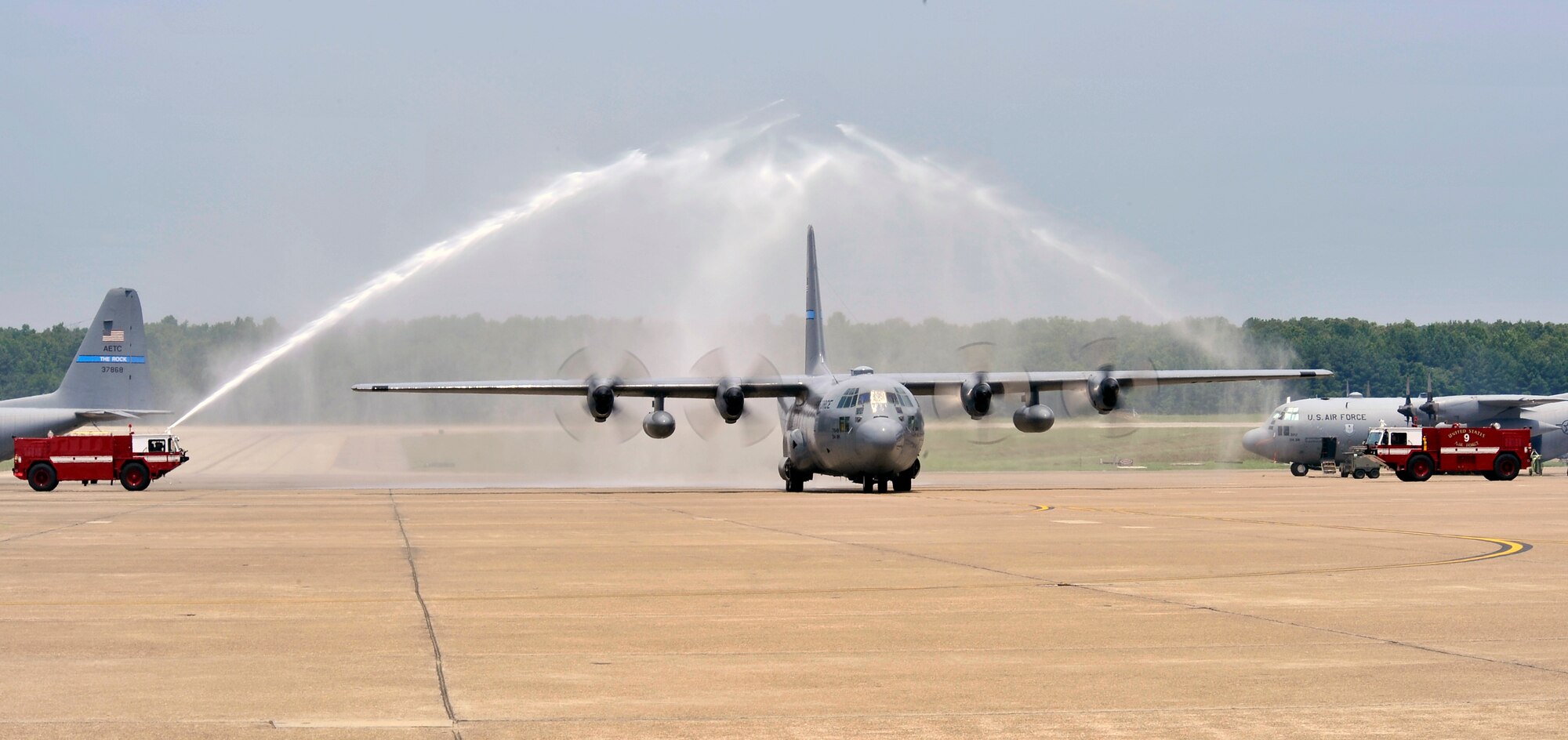 The spray of base fire trucks welcome Col. Mark Vlahos, 314th Airlift Wing vice commander, as he taxis in upon the completion of his final flight at Little Rock Air Force Base July 10. The colonel’s next assignment is at Randolph AFB, Texas where he will serve as the 19th Air Force assistant director of operations.  The colonel has served as the 314 AW’s vice commander since July 2007. The 314 AW’s mission is to train C-130 aircrews for all services in the Department of Defense, Coast Guard and 34 allied nations, as well as C-21 aircrew through the 45th Airlift Squadron at Keesler AFB, Miss. (U.S. Air Force photo by Staff Sgt. Chris Willis)