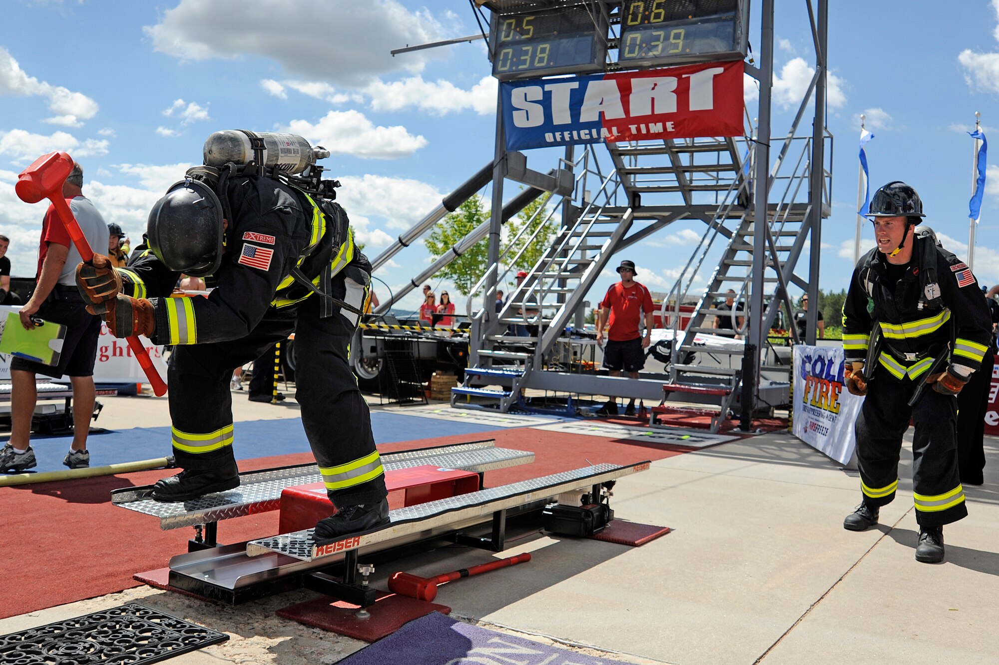 Marine Sgt William Alexander hits the Keiser Sled  and Army Staff Sgt Stephen Burpee waits for the baton exchange during the relay competition. (U.S. Air Force Photo by Mike Kaplan)
