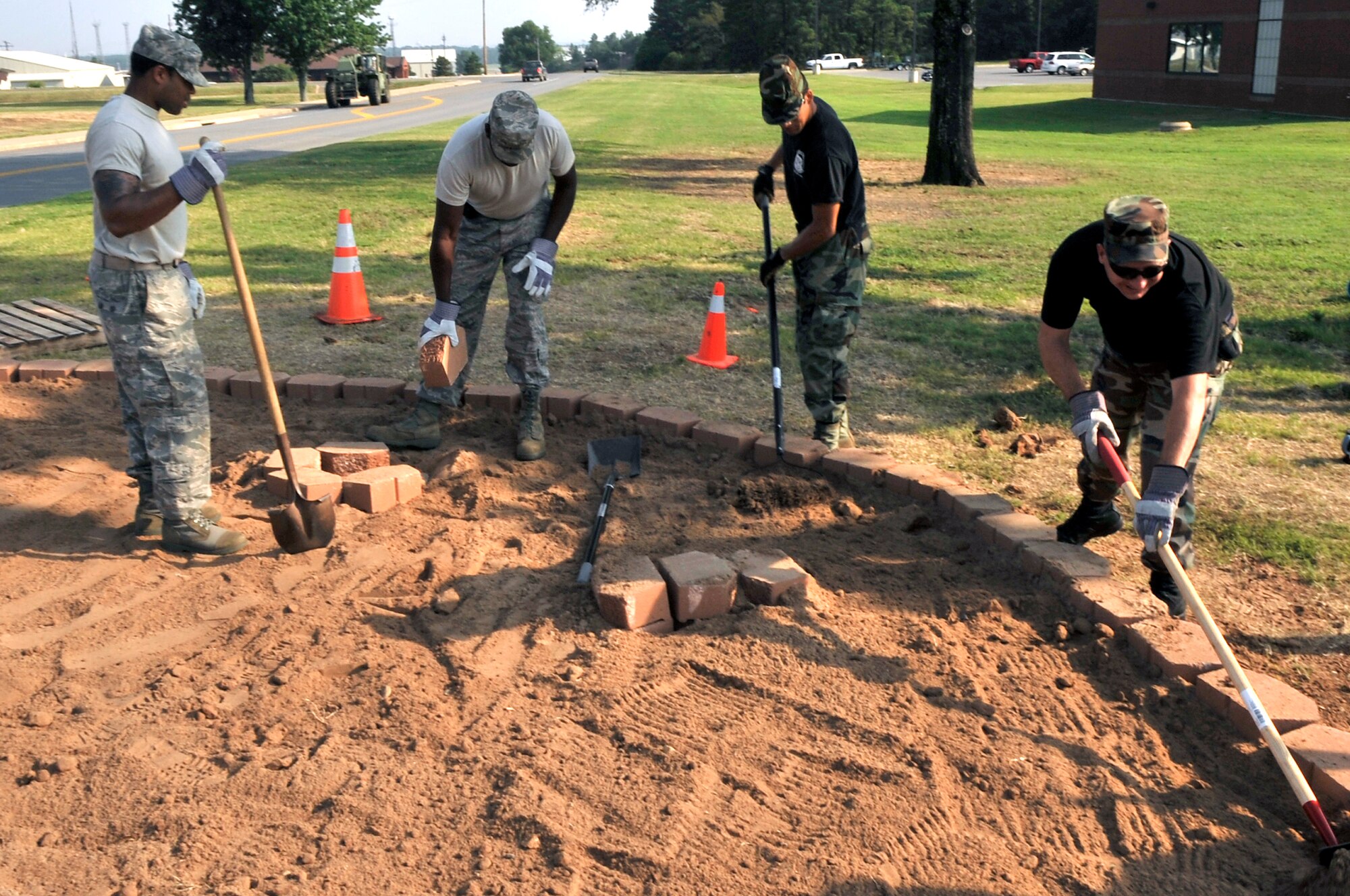 Airmen from Little Rock Air Force Base lay the groundwork for a base beautification project near the fitness center July 10. The $20,000 project, managed by the 19th Mission Support Group and funded by Air Mobility Command, will target five high-traffic areas on base and is focused on using natural plants from the "Natural State" as renewable resources to increase the aesthetic appeal of the base. (U.S. Air Force photo by Staff Sgt. Chris Willis)