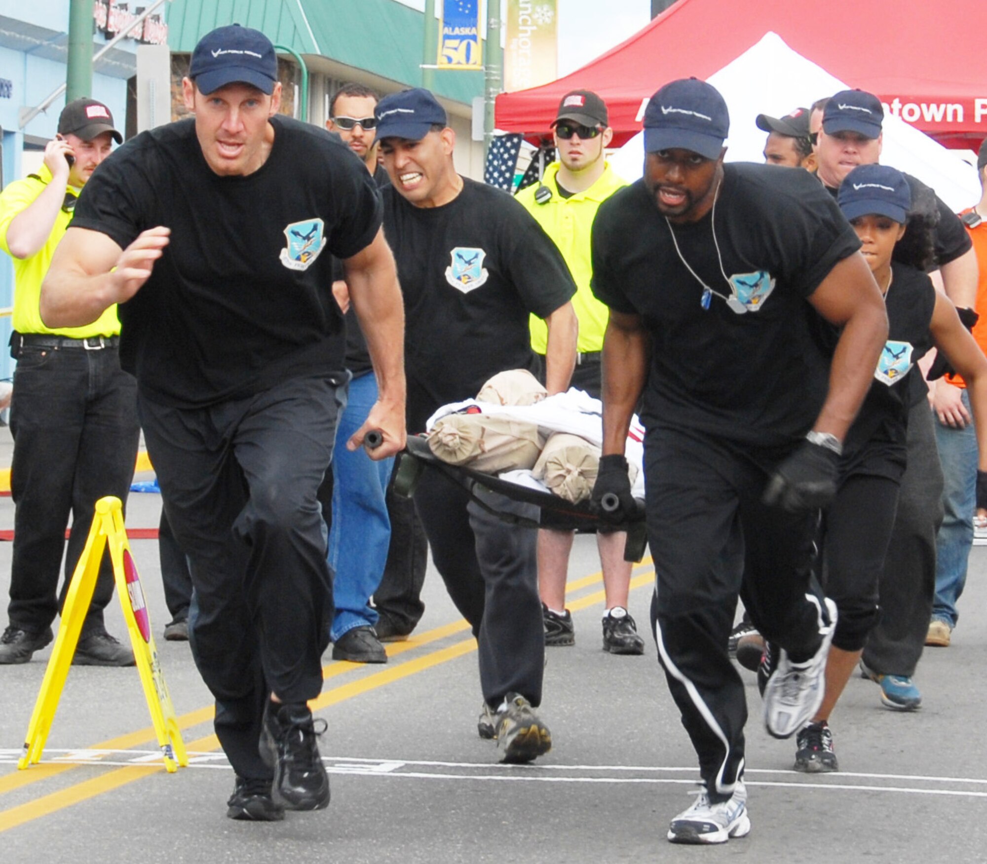 Representing the 477th Fighter Group, the Double Deuces carry a 200-pound dummy during the litter carry event at the 2009 Hero Games June 27, 2009, in downtown Anchorage, Alaska. From left are Lt. Col. Dave Piffarerio, Tech. Sgt. Jorge Mendoza, Staff Sgt. Spencer Walcott and Staff Sgt. Danielle Foster. The Air Force reservists are assigned to Elmendorf Air Force Base, Alaska. (U.S. Air Force photo/Staff Sgt. Andrea Knudson)

