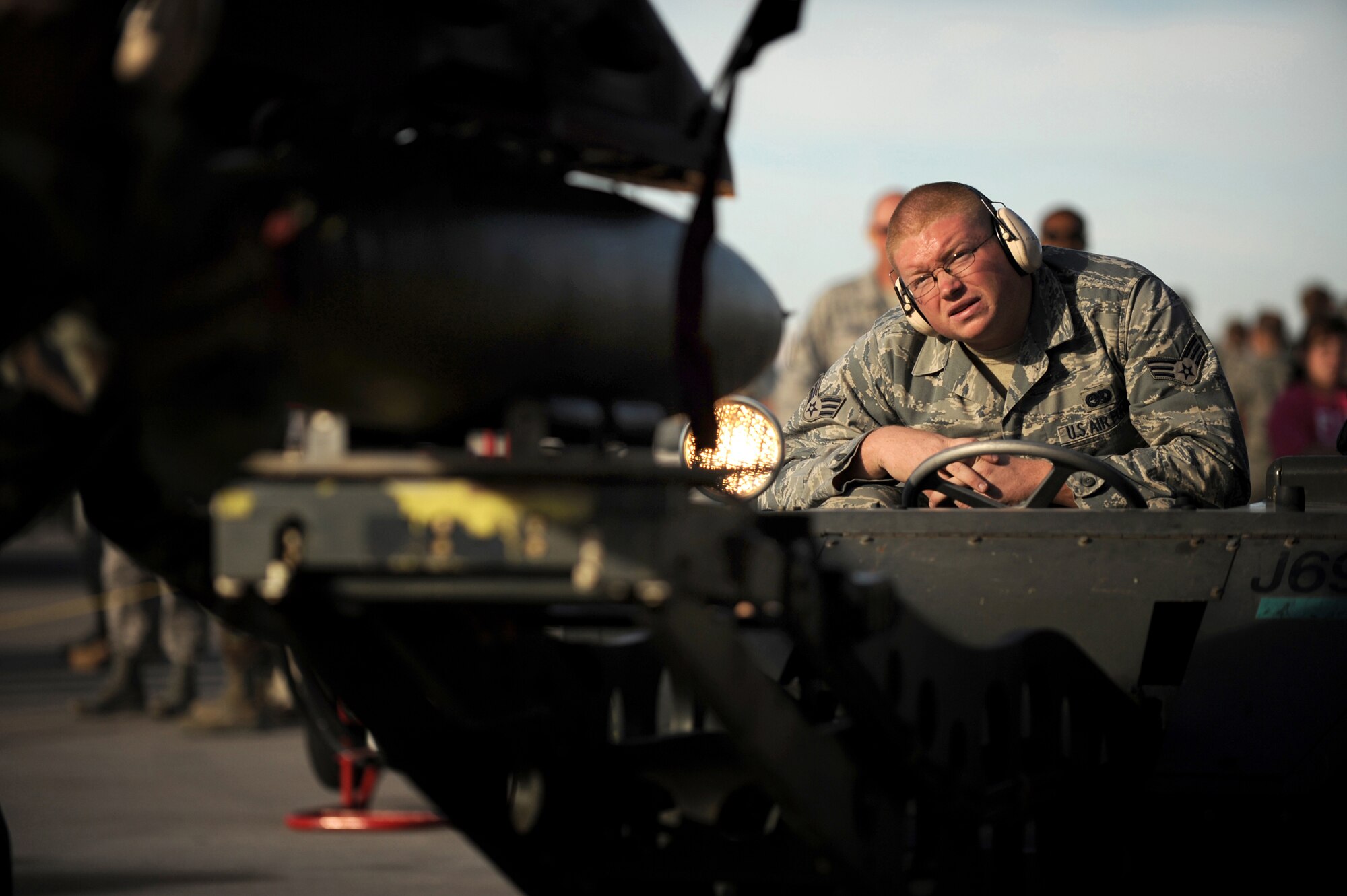 Senior Airman Casey Frye from the 57th Aircraft Maintenance Squadron, Viper AMU uses a MJ-1 (Jammer) to position an MK-182 bomb on an F-16 Falcon during a weapons load competition at Nellis Air Force Base, Nev., on July 8, 2009. Weapons load competitions are conducted bi-monthly to keep Airman sharp while recognizing a job well done.  Load Crews are evaluated for use of the checklist, safety, and overall speed.  (U.S. Air Force Photo/Tech. Sgt. Michael R. Holzworth)
