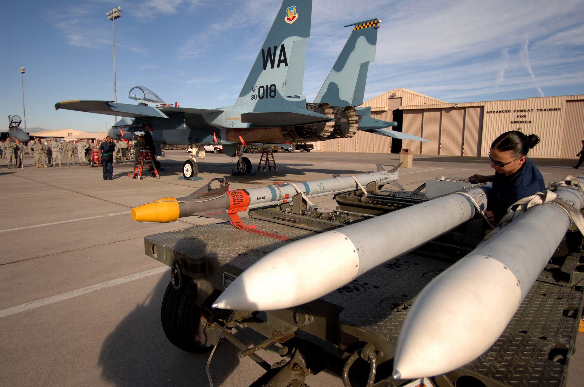 Airman 1st Class Kayce Stout from the 57th Aircraft Maintenance Squadron, Eagle AMU inspects and removes the cargo strap from an AIM-120 air-to-air tactical missile during a weapons load competition at Nellis Air Force Base, Nev., on July 8, 2009. Weapons load competitions are conducted bi-monthly to keep Airman sharp while recognizing a job well done.  Weapons Load Crews are evaluated for use of the checklist, safety, and overall speed. (U.S. Air Force Photo/Tech. Sgt. Michael R. Holzworth)


