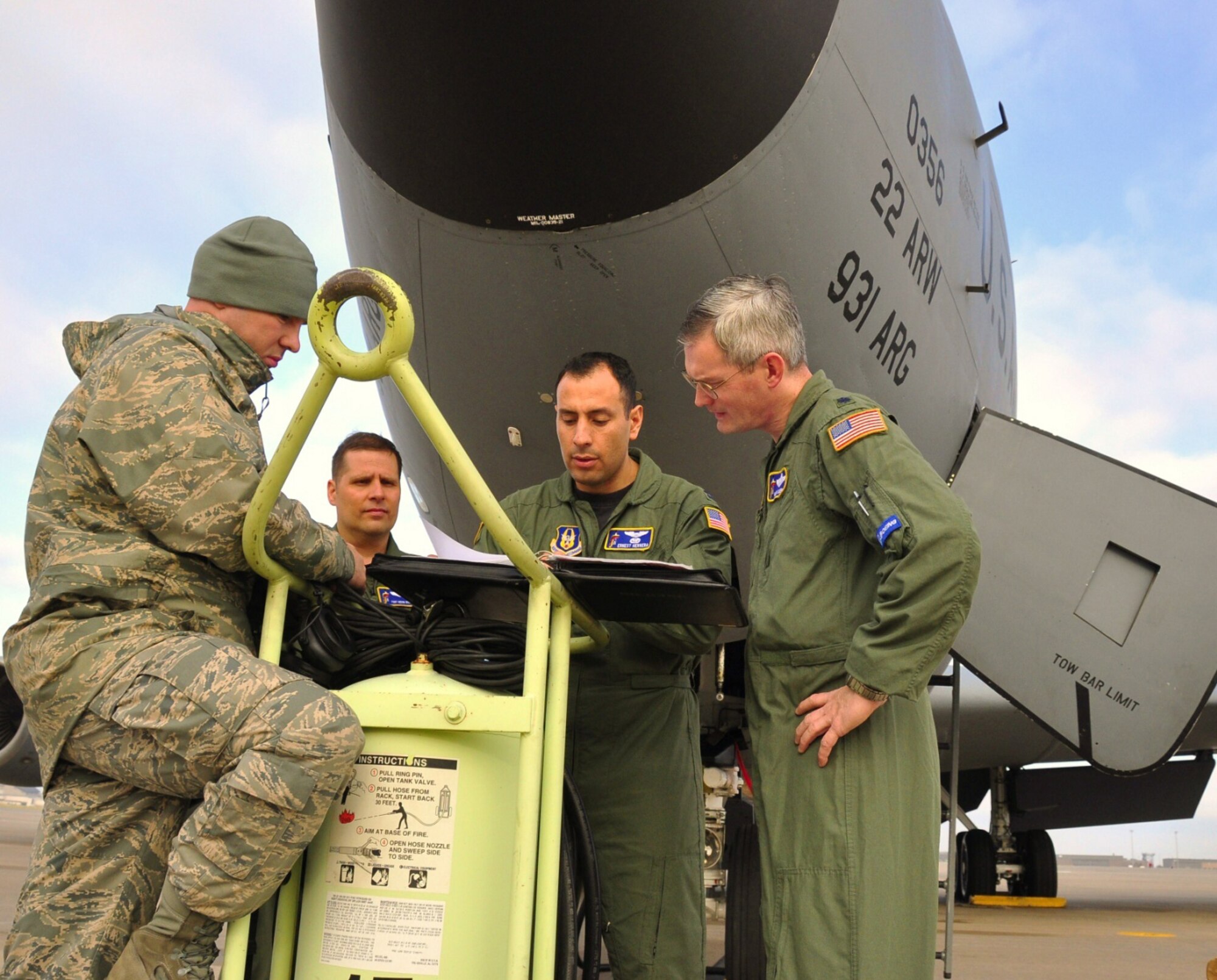 Reservists assigned to the 931st Air Refueling Group go over a maintenance logbook to a KC-135 Stratotanker prior to a training mission in April, 2009. The 931st ARG is an Air Force Reserve unit at McConnell Air Force Base, Kan. (Courtesy photo/Lt. Col. Tsuyoshi Tung)