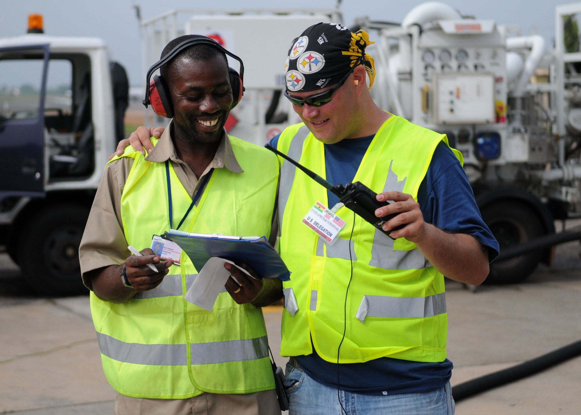 Tech. Sgt. Paul Farrow, 435th Logistics Readiness Squadron, a petroleum, oils and lubricants craftsman, from Ramstein Air Base, Germany, gives Isaac Henaku a friendly hug while fueling six aircraft refuel trucks at Kotoka International Airport July 6, 2009, at Accra, Ghana. Sergeant Farrow is one of more than 150 Airmen, Sailors and Marines in Ghana and Sailors aboard the USS Iwo Jima who make up a task force supporting U.S. President Barack Obama’s visit July 10 and 11. Mr. Henaku is a supervisor at Total Petroleum Ghana Ltd.

The mission is being conducted by 17th Air Force, also known as Air Forces Africa, at Ramstein Air Base, Germany. Seventeenth Air Force is the air component for U.S. Africa Command. The task force is providing aerial port and aircraft maintenance teams, along with forward communications, early warning and air domain safety and security elements to support the President’s visit, his first to the African continent since taking office in January. In addition to supporting the visit, members are working with their Ghanaian counterparts to strengthen the partnership between the two nations. (U.S. Air Force photo by Staff Sgt. Jerry Fleshman)