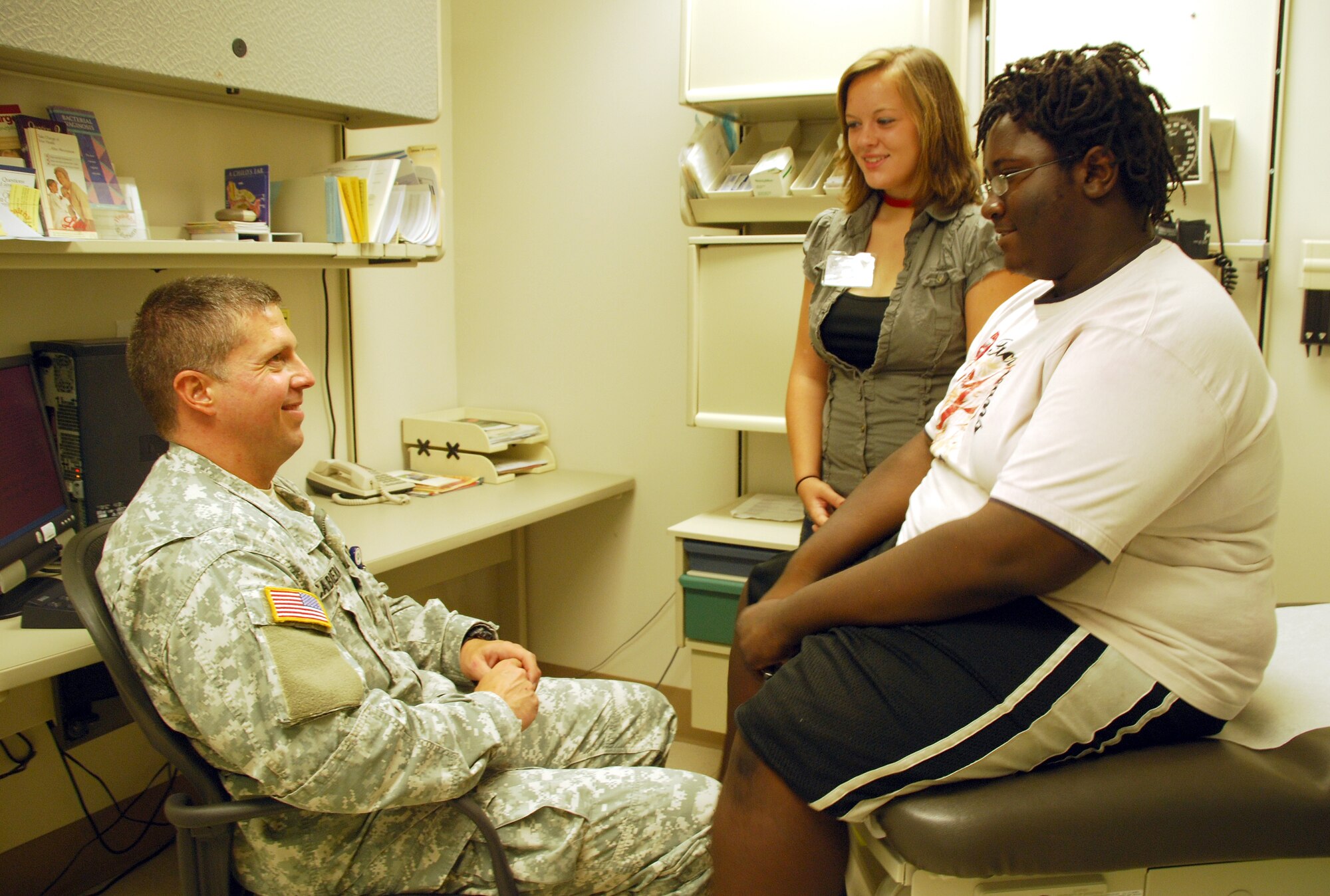Principal Investigator, Maj. Jorge Cabrera, Department of Clinical Investigations with Brooke Army Medical Center converses with  Kaitlin Sheridan and Lyynel Reed Washington about their progress in the research. The goal of the research is to reach 100 volunteers to participate in this research. (U.S. Army photo)