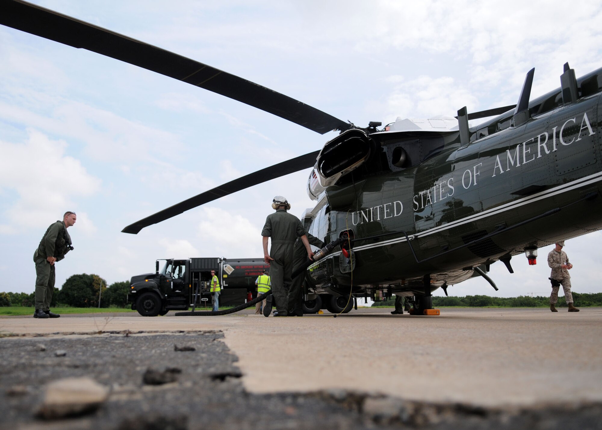Members of the 435th Logistics Readiness Squadron, a petroleum, oils and lubricants team from Ramstein Air Base, Germany, assist with refueling Marine One at Kotoka International Airport July 6, 2009, at Accra, Ghana. 

The Airmen are among more than 150 Airmen, Sailors and Marines in Ghana and Sailors aboard the USS Iwo Jima who came together to form a task force to support President Obama’s visit July 10 and 11. The mission is being conducted by 17th Air Force, also known as Air Forces Africa, at Ramstein Air Base, Germany. Seventeenth Air Force is the air component for U.S. Africa Command. The task force is providing aerial port and aircraft maintenance teams, along with forward communications, early warning and air domain safety and security elements to support the President’s visit, his first to the African continent since taking office in January. In addition to supporting the visit, members are working with their Ghanaian counterparts to strengthen the partnership between the two nations. (U.S. Air Force photo by Staff Sgt. Jerry Fleshman)