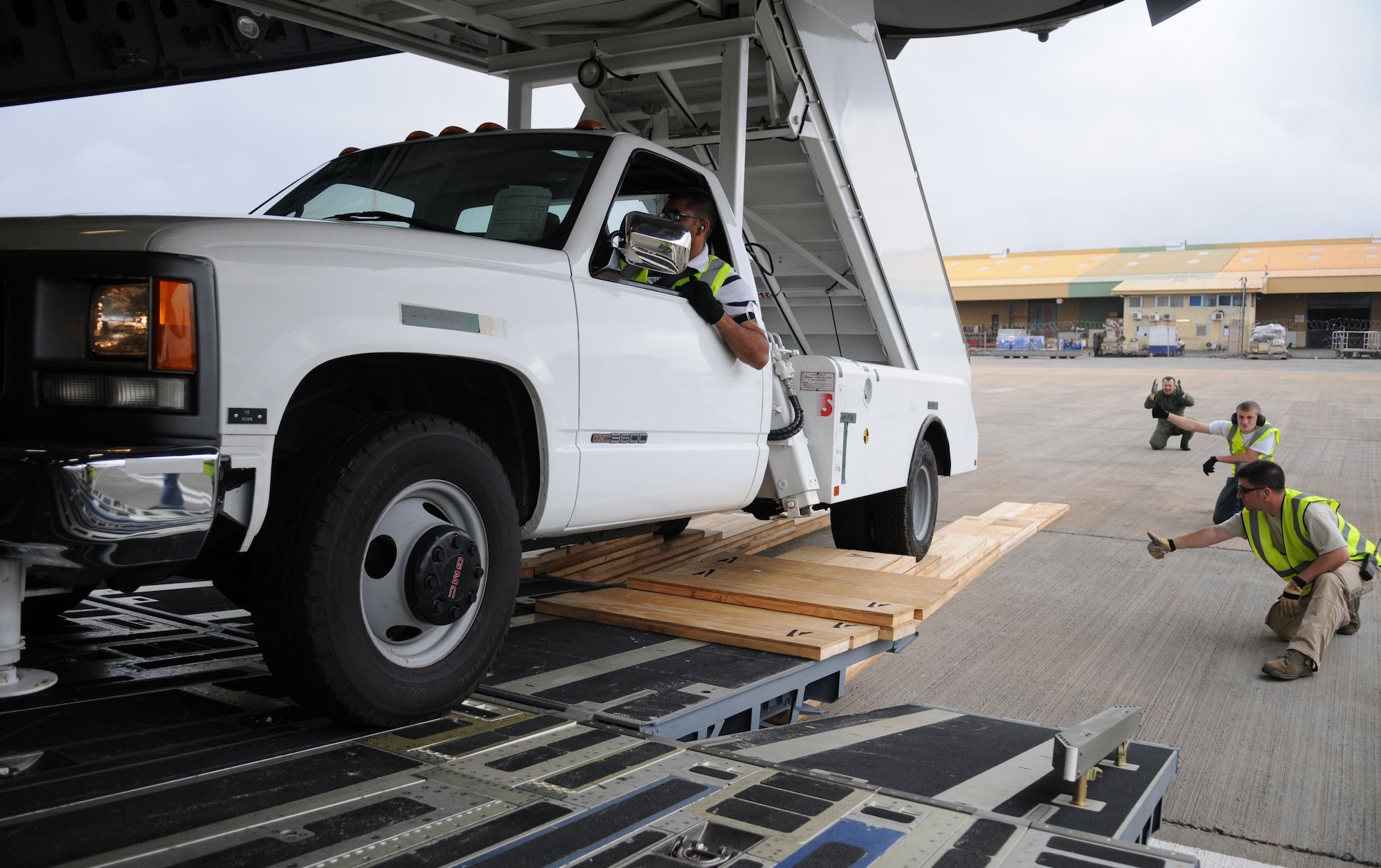 Members of the 621st Contingency Response Wing at McGuire Air Force Base, N.J., along with C-17 aircrew members from Charleston Air Force Base, S.C., work together to ensure proper clearance during offloading operations of a stair truck at Kotoka International Airport July 6, 2009, at Accra, Ghana. 

The Airmen are among more than 150 Airmen, Sailors and Marines in Ghana and Sailors aboard the USS Iwo Jima who form a task force supporting President Obama’s visit July 10 and 11. The mission is being conducted by 17th Air Force, also known as Air Forces Africa, at Ramstein Air Base, Germany. Seventeenth Air Force is the air component for U.S. Africa Command. The task force is providing aerial port and aircraft maintenance teams, along with forward communications, early warning and air domain safety and security elements to support the President’s visit, his first to the African continent since taking office in January. In addition to supporting the visit, members are working with their Ghanaian counterparts to strengthen the partnership between the two nations. (U.S. Air Force photo by Staff Sgt. Jerry Fleshman)