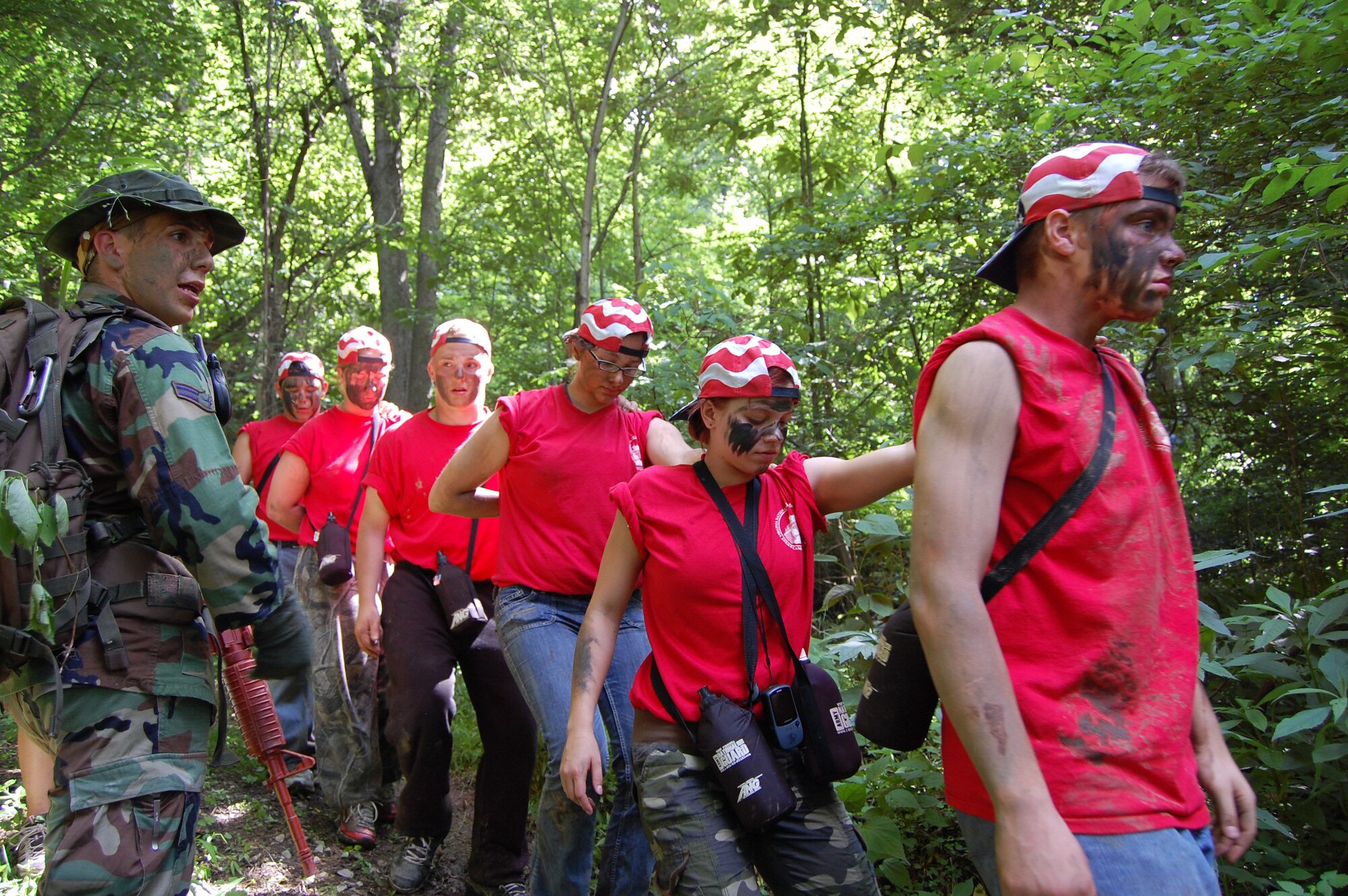 167th Airlift Wing member, Airman First Class Jack Messner guides campers out of a wooded area as part of an escape and evade exercise during the West Virginia Youth Leaders Camp at Camp Dawson near Kingwood, WV. Sixty-six high schoolers from West Virginia participated in the week-long camp now in its forty-third year. Youth Leaders Camp,  geared toward building confidence and instilling leadership skills, challenges the campers with mentally and physically demanding activities. (U.S. Air Force Photo by SSgt Sherree Grebenstein)