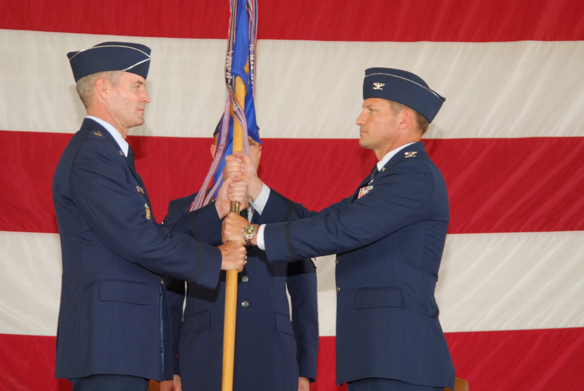 Col. Michael Fleck assumes command of the 325th Mission Support group from Brig. Gen. Darryl Roberson, 325th Fighter Wing commander, during a ceremony July 9, in Hangar 2.  