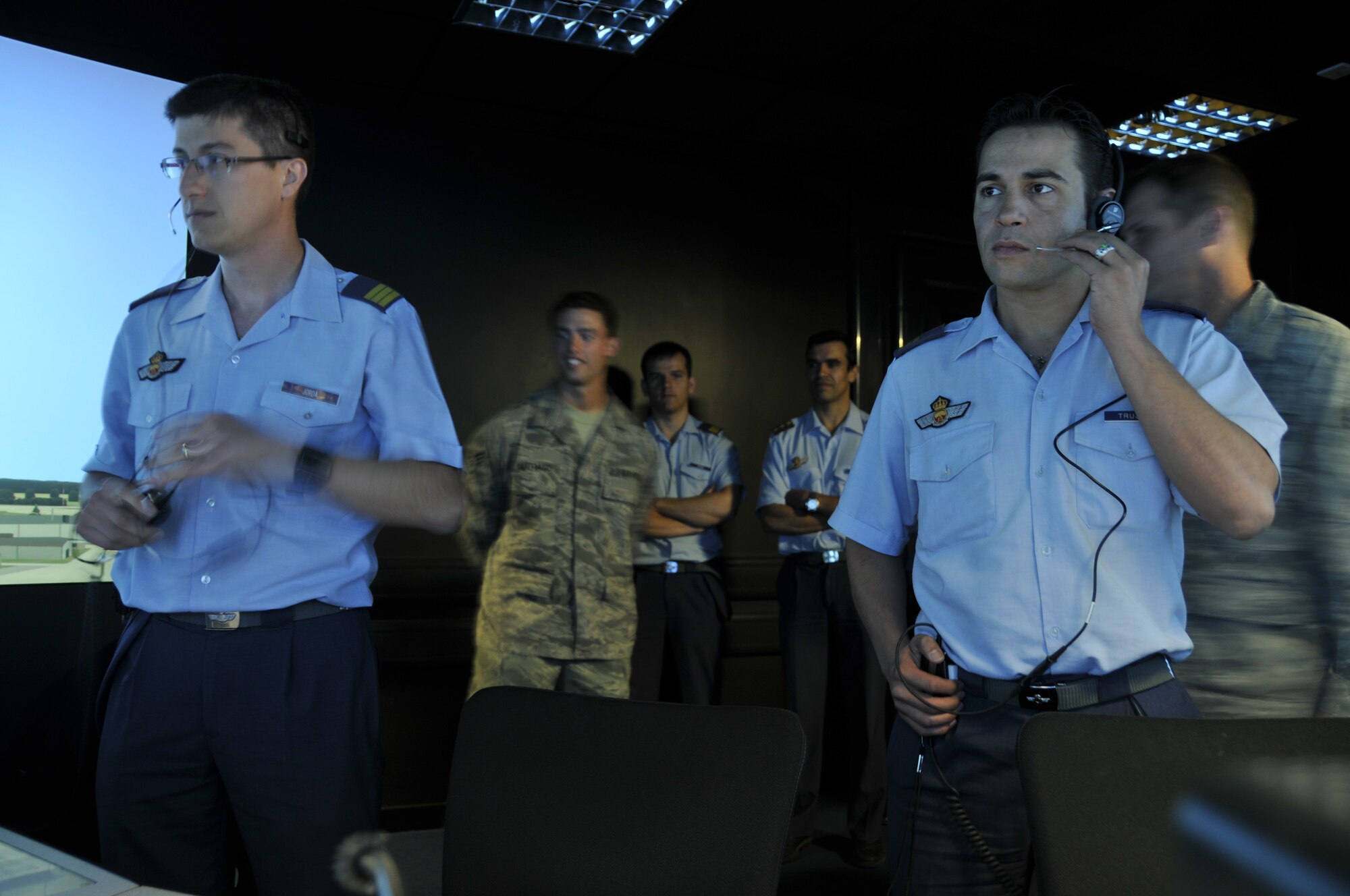 Sergeants Rafael Trujillo (right) and Ignacio Jorda (left), Spanish air traffic controllers, receive training at RAF Lakenheath from the 48th Operations Support Squadron air traffic controllers at the tower simulator July 10, 2009. The Spanish controllers were at the Liberty Wing to become familiar with American phraseology (specific verbiage used to talk to aircraft) and procedures prior to their upcoming deployment in support of NATO operations. (U.S. Air Force photo by Tech. Sgt. Chris Stagner)