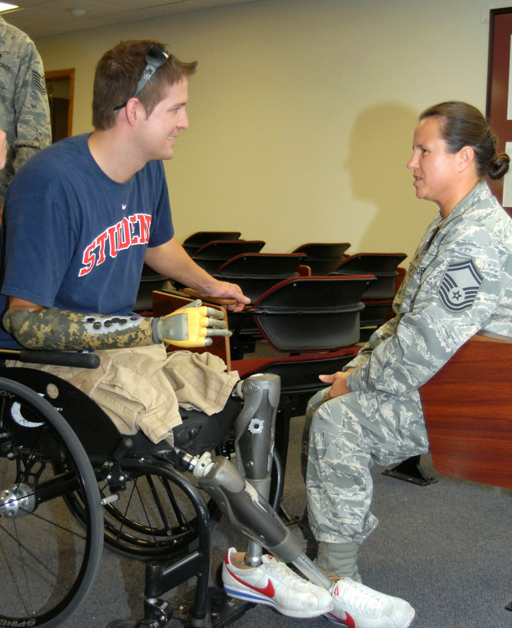 Brian Kolfage, former 17th Security Forces Squadron defender now retired Senior Airman, speaks to Senior Master Sgt. Annette Whitenack at Goodfellow AFB, Texas, on July 2. Brian spoke about his experience on Sept. 11, 2004, a rocket attack left him without legs and a right arm. Senior Master Sgt Whitenack was one of the first medical responders on scene after Brian was injured. (U.S. Air Force photo by Robert Martinez)