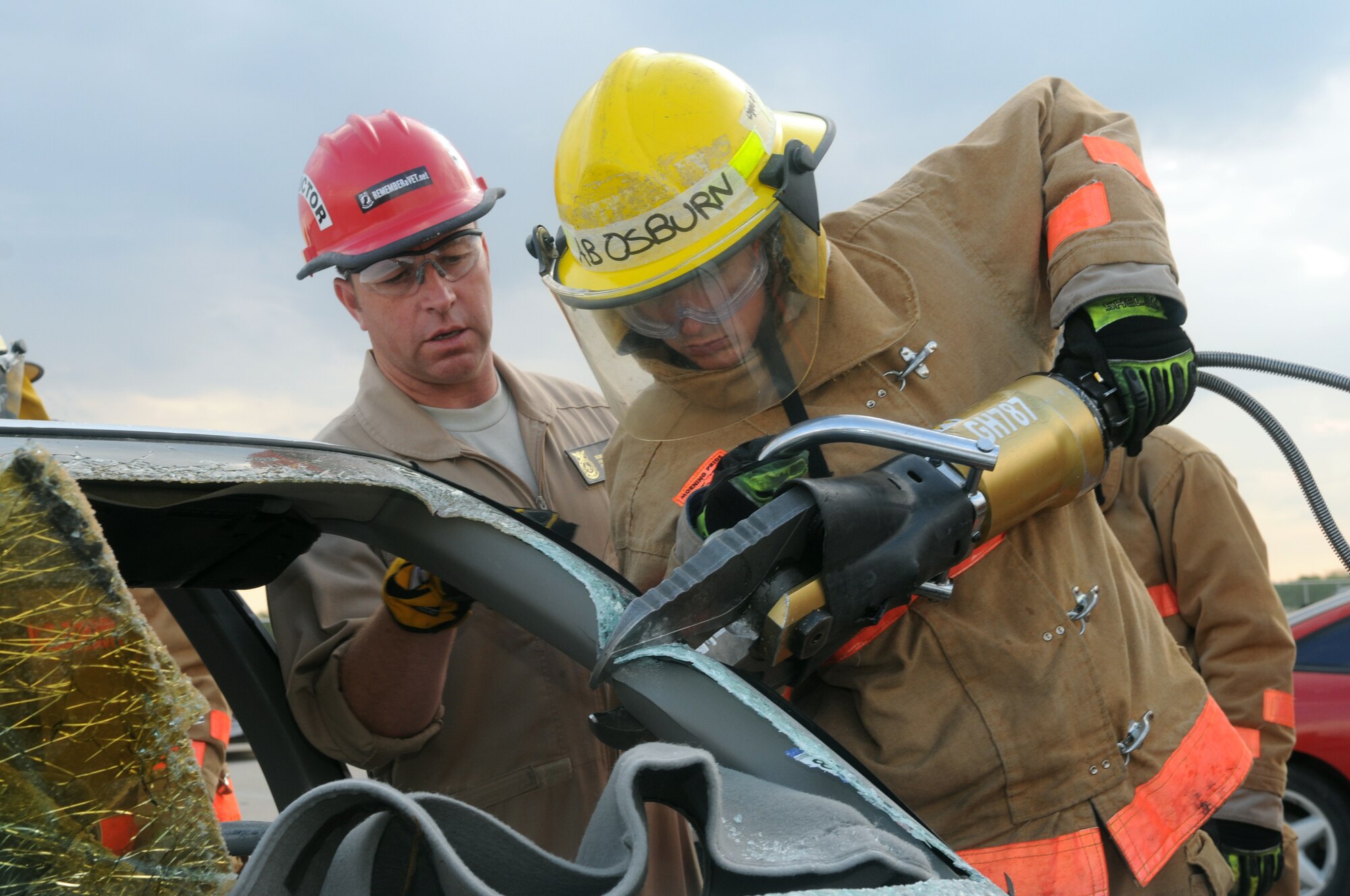 Airman Seth Osburn uses the Jaws of Life to cut open a car during block 3 (firefighter principles) of firefighter training while instructor Shane McMullen observes. (U.S. Air Force photo by Tech. Sgt. John Barton)   