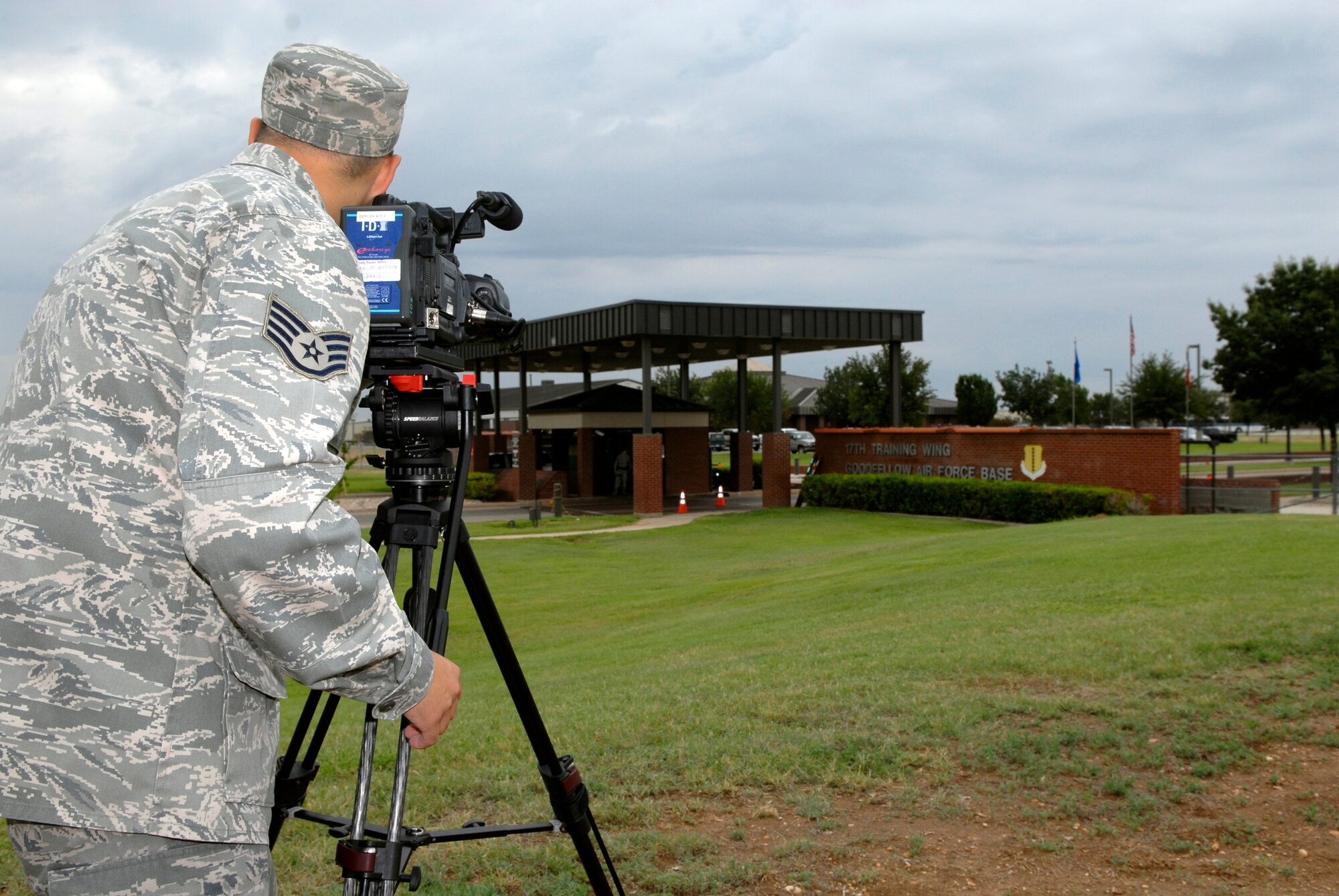Staff Sgt. Jon DuMond, a video broadcaster with the 17th Training Wing Public Affairs office, sets up a video camera to record incoming traffic at the north gate. (U.S. Air Force photo by Lou Czarnecki)
