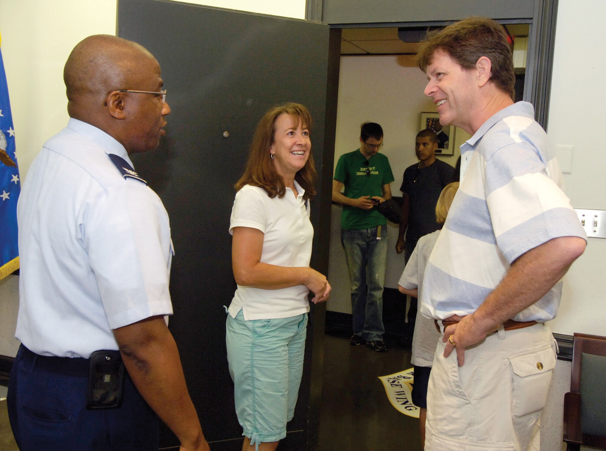 Members of Maj. Gen. Clarence Tinker’s family from across the country came to Tinker Air Force Base for a brief visit June 29. The 17-member extended family planned a trip to General Tinker’s birthplace of Pawhuska during the annual family reunion. Above, Michael E. Tinker and his wife, Karen, visit with 72nd Air Base Wing and Tinker Installation Commander Col. Allen Jamerson. Colonel Jamerson welcomed the family to the base and honored each with a wing coin.  Mr. Tinker, from Virginia, is the grandnephew of the base’s namesake. (Air Force photo by Margo Wright) 
