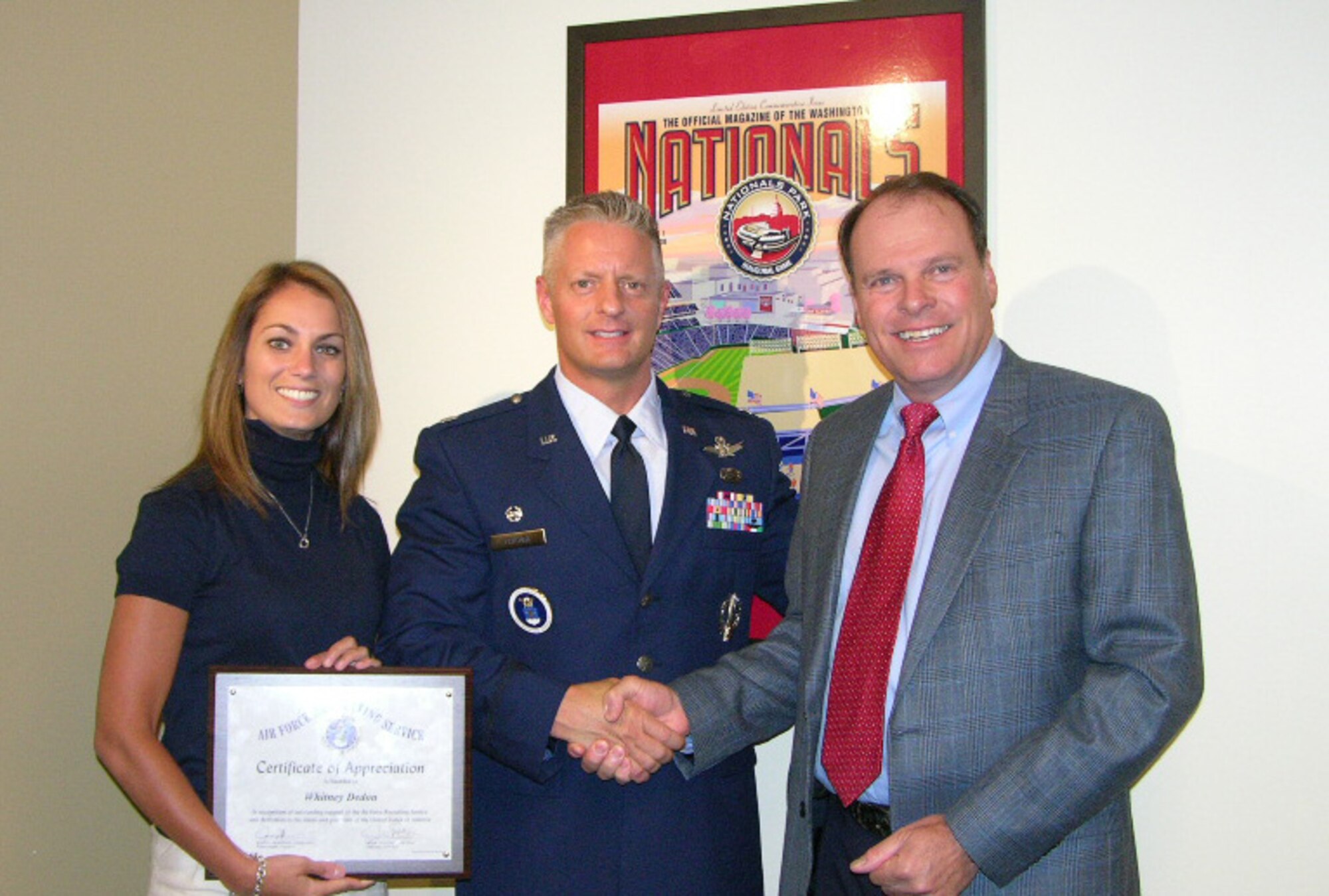Lt. Col. John Feather, 317th Recruiting Squadron commander, presents a certificate of appreciation to John Myers (right) and Whitney Dedon (left), corporate partnership representatives from the Washington Nationals baseball team. Partnerships between community organizations are key to the success of Air Force recruiting. The 317th RCS, headquartered in Oxon Hill, Md., is recruiting throughout the season at the Nationals ballpark. (U.S. Air Force photo/Tech. Sgt. Stephen Sutton)

