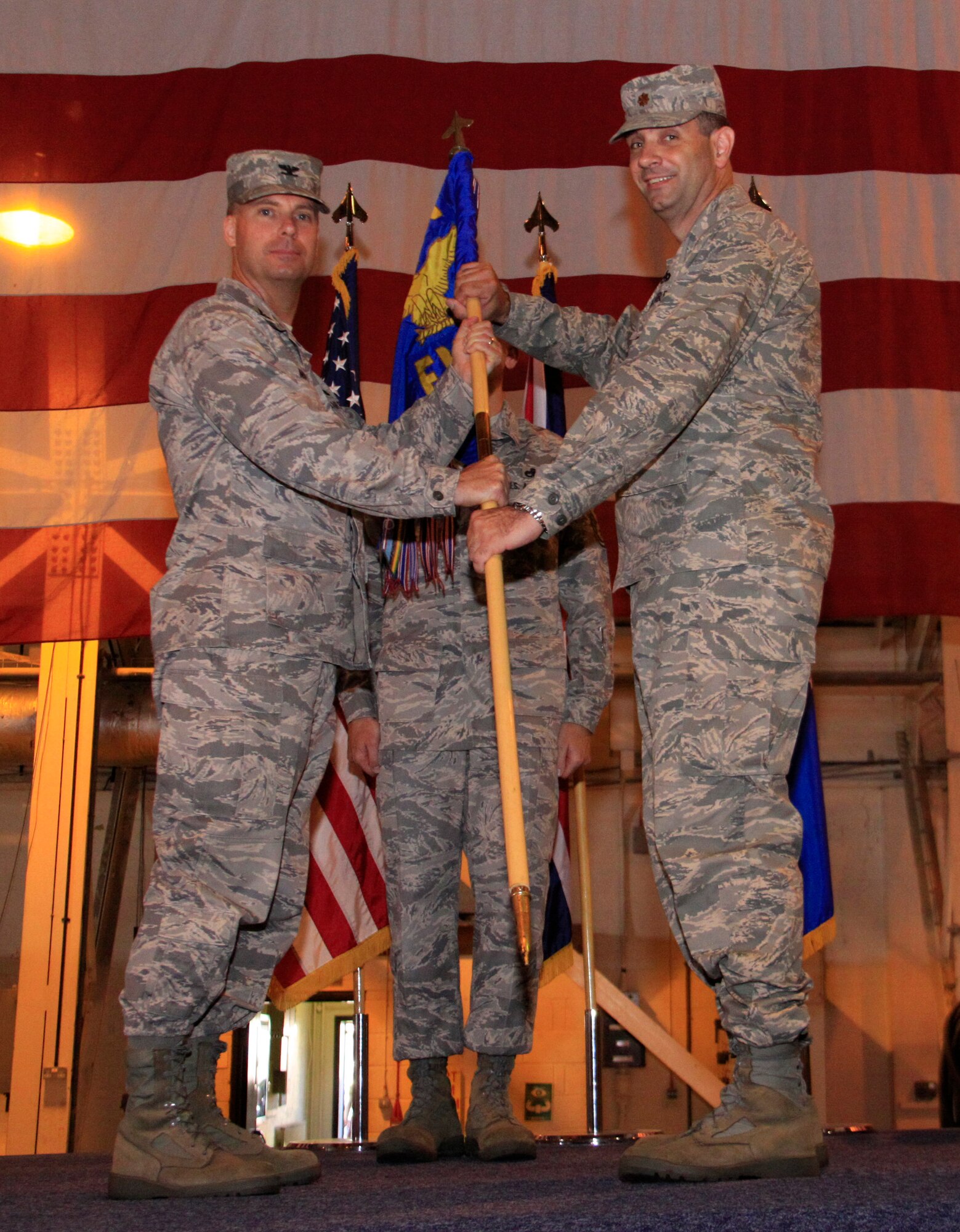 Col. Marcus Novak, 48th Maintenance Group commander, passes the guidon to Maj. Michael Wigen as he takes command of the 48th Equipment Maintenance Squadron at RAF Lakenheath, England, on June 30, 2009. (U.S. Air Force photo by Staff Sgt. Timothy Sanford)