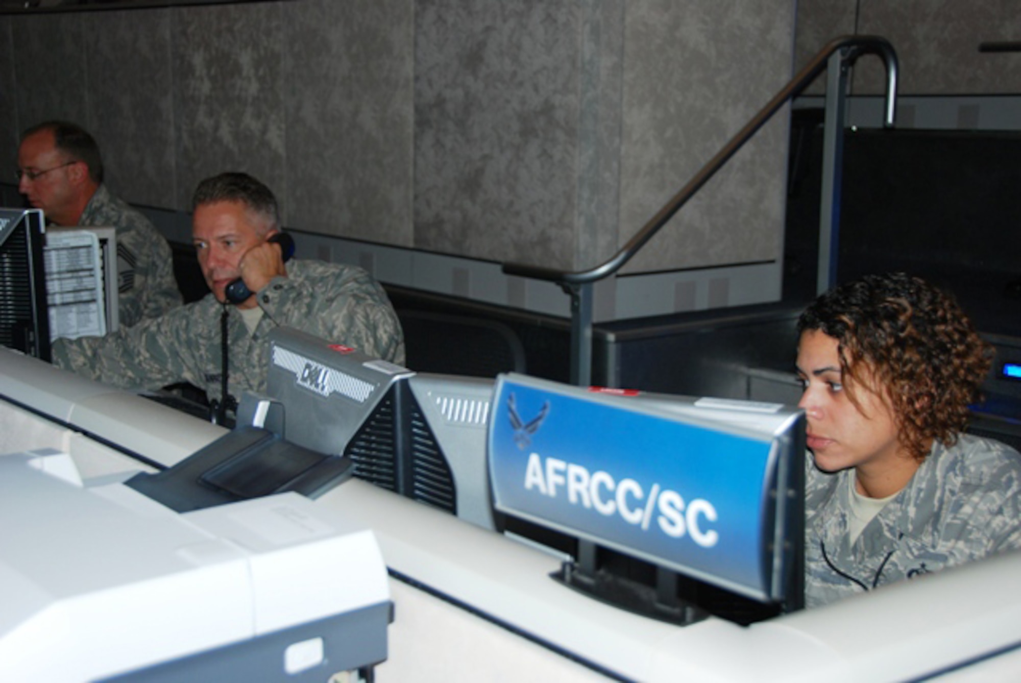 Search and rescue coordinators Major Bill Kennedy and Staff
Sergeant Diane Brown monitor ongoing search and rescue operations.  The Air
Force Rescue Coordination Center serves as the single agency responsible for
coordinating life saving federal search and rescue services. (US Air Force Photo by 1st Lt. Andrew Scott)
