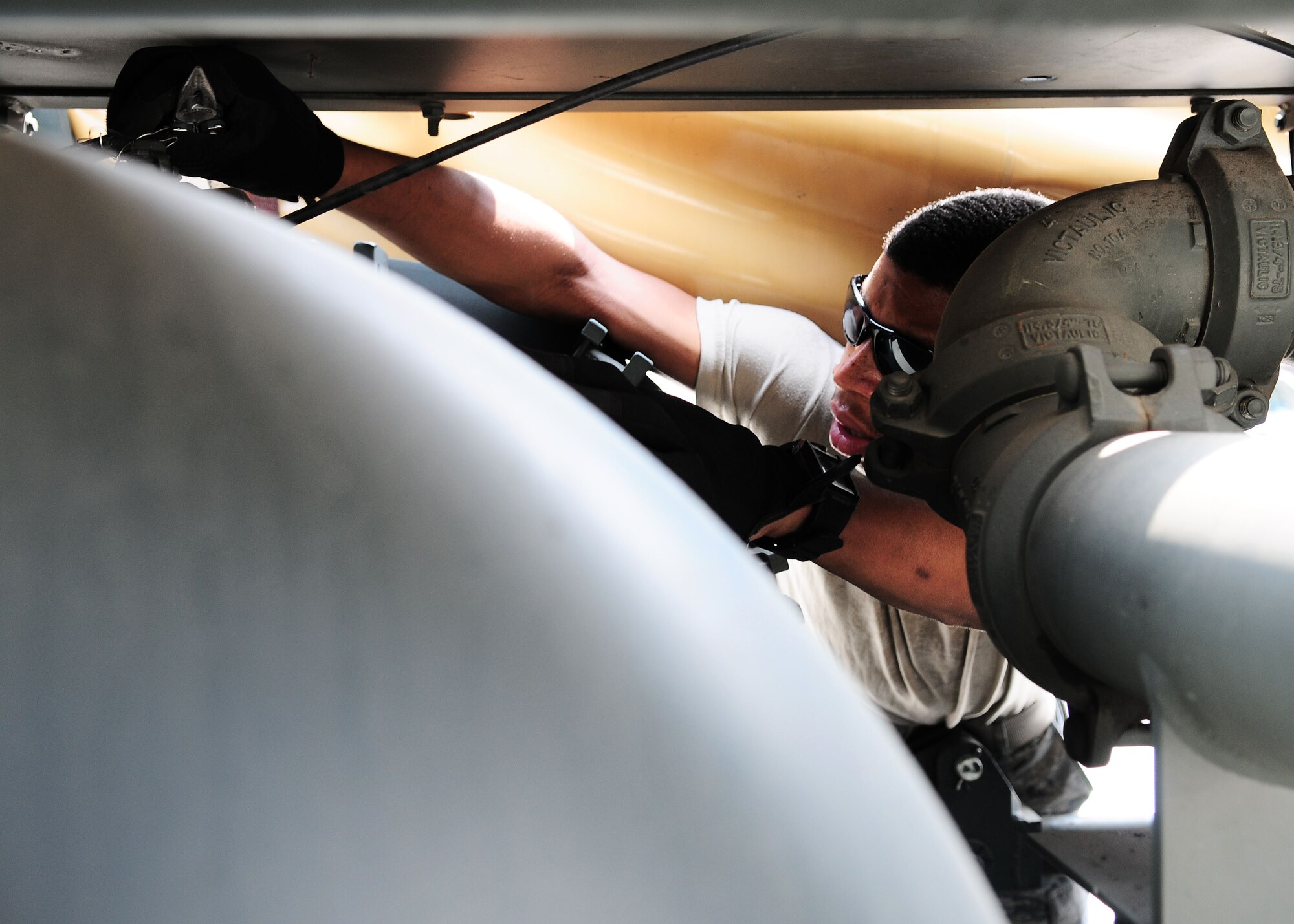 YOKOTA AIR BASE, Japan -- Airman Christopher Mitchell, 374th Logistics Readiness Squadron Fuels Management Flight, adjusts a valve on an R-14, a piece of fuels mobility support equipment, recently. Airmen use the R-14 to pump fuel from a fuel bladder or tank to another source such as an aircraft or a fuel truck. (U.S. Air Force photo/Airman 1st Class Michael Dillon)