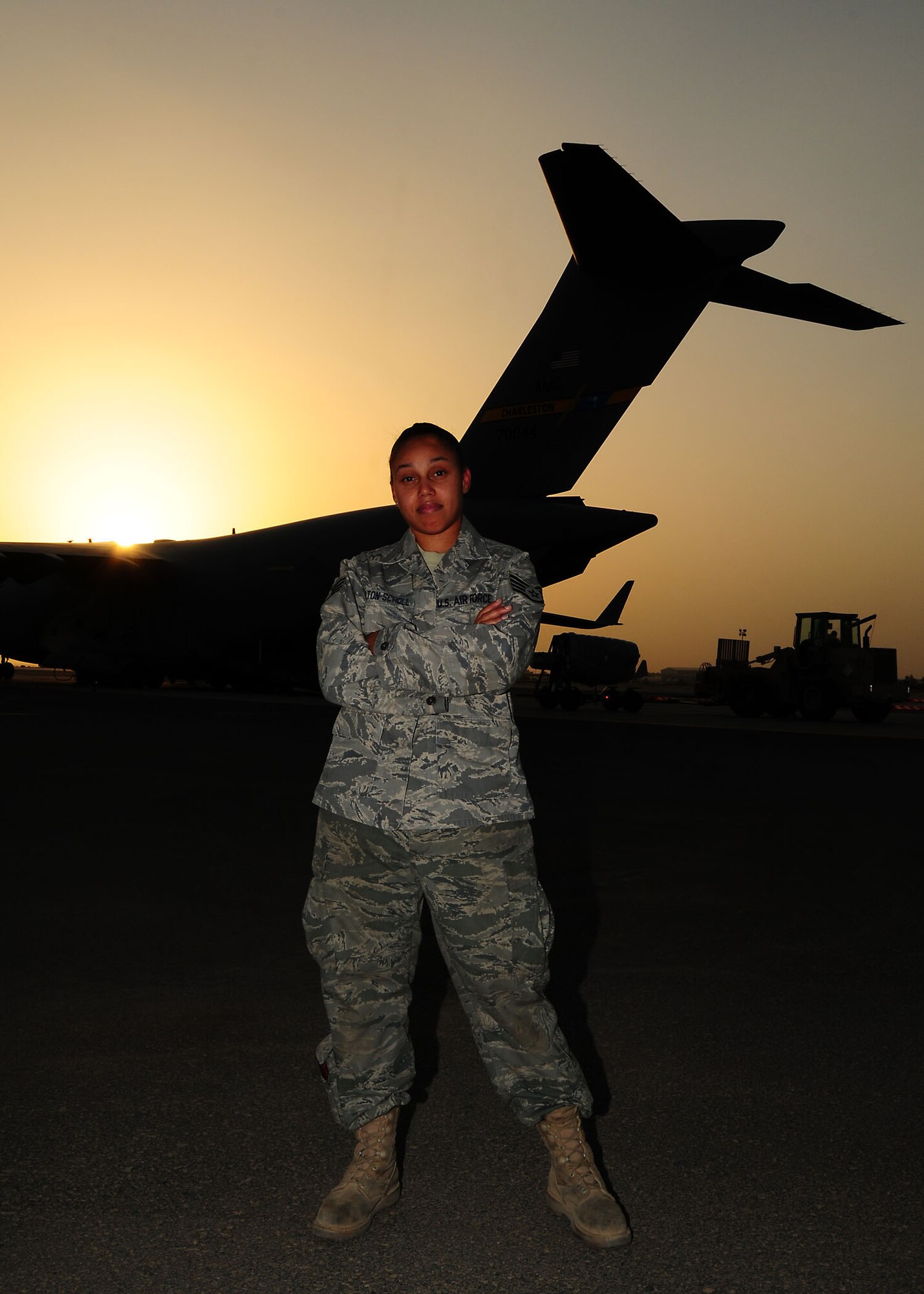 Staff Sgt. Channel Bolton-Scholl, 5th Expeditionary Aircraft Maintenance Squadron maintainer, stands with a C-17 Globemaster III aircraft in the background on the flightline of the 386th Air Expeditionary Wing. Sergeant Bolton-Scholl was named on the Air Force's 12 Outstanding Airmen July. 2. Sergeant Bolton-Scholl is deployed from McChord Air Force Base, Wash. (U.S. Air Force photo/Tech. Sgt. Tony Tolley)