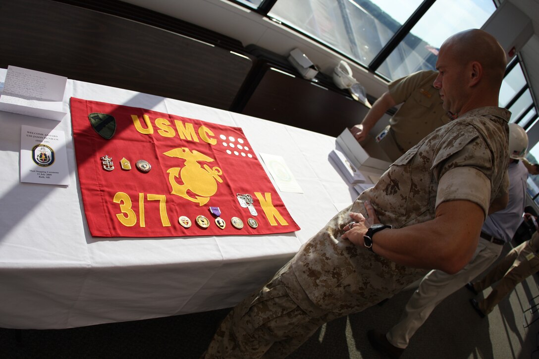 Maj. Trent A. Gibson, the executive officer for 2nd Battalion, 7th Marine Regiment, and Medal of Honor recipient Cpl. Jason Dunham’s former company commander, admires the display of items that were permanently sealed in the destroyer, the USS Jason Dunham, named after the only Marine to be awarded the Medal of Honor since Vietnam.
