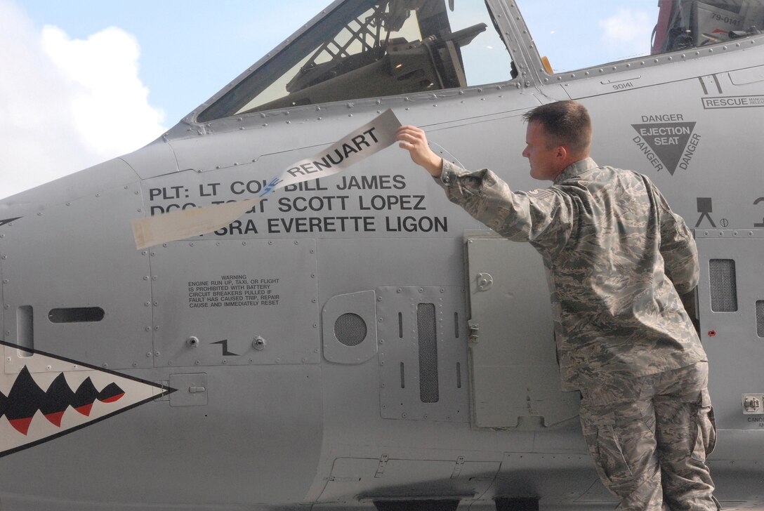 Tech. Sgt. Scott Lopez, an A-10 Thunderbolt II crew chief with the 476th Maintenance Squadron, reveals the name of A-10 pilot, Lt. Col. Bill James, in a special unit-activation ceremony held at Moody Air Force Base, Ga., July 11, 2009.  Colonel James is the commander of the newly activated 76th Fighter Squadron, part of an Air Force Reserve Command A-10 associate unit here. The parent unit of the 476th MXS, the also newly-formed 476th Fighter Group, fly's the 23rd Wing's aircraft in a program that is a partnership with the Regular Air Force.  (U.S.  Air Force photo/Master Sgt. Bill Huntington)  