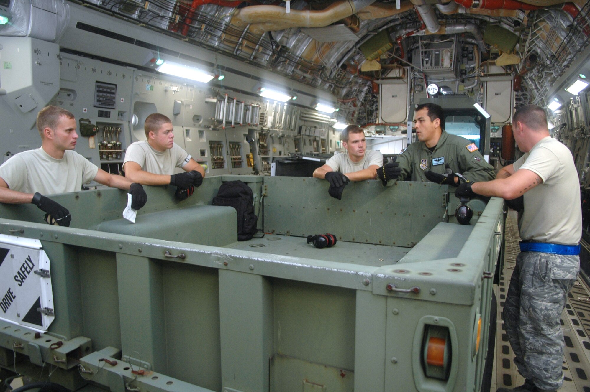 Tech. Sgt. Harry Pollock, a loadmaster with the 512 Arilift Wing, Dover Air Force Base, Del., has a meeting with members of the 46th Aerial Port Squadron, Dover AFB, after a July 9 practice run for the upcoming Air Mobility Command Rodeo. Sergeant  Pollock and 46th APS members will be participating with Team Dover in the 2009 AMC Rodeo July 19-24 at McChord AFB, Wash. (Air Force Photo/2nd Lt Joe Simms)