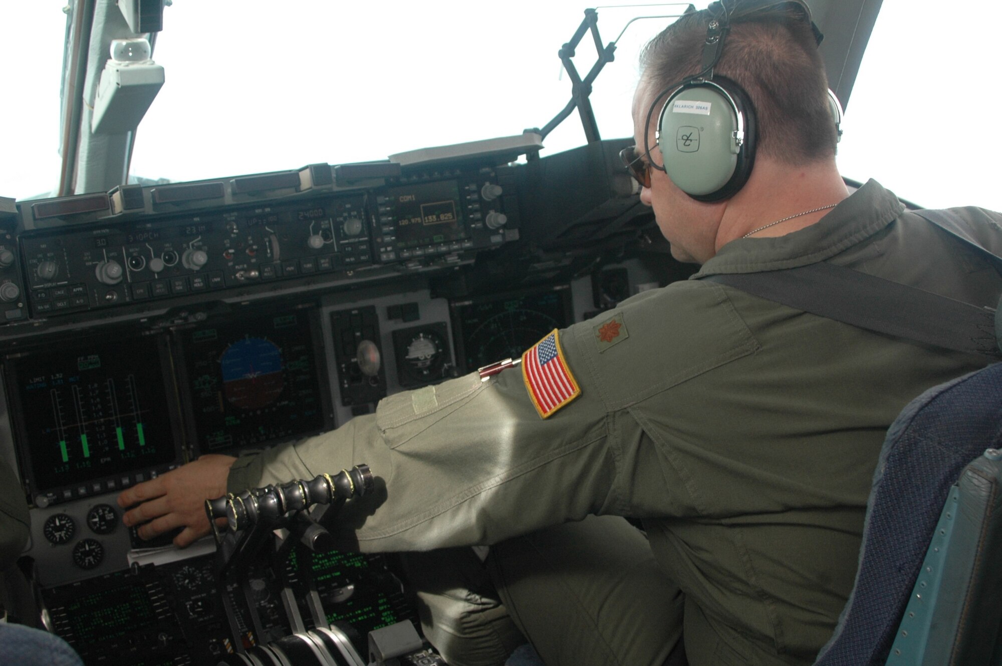 Maj. Rich Klarich, 512th Airlift Wing, Dover Air Force Base, Del., checks his fuel gauges while on a C-17 training mission July 9 in preparation for the Air Mobility Command Rodeo July 19-24 at McChord AFB, Wash. Major Klarich will be participaing with Team Dover in the biannual event. (U.S. Air Force Photo/2nd Lt. Joe Simms) 
