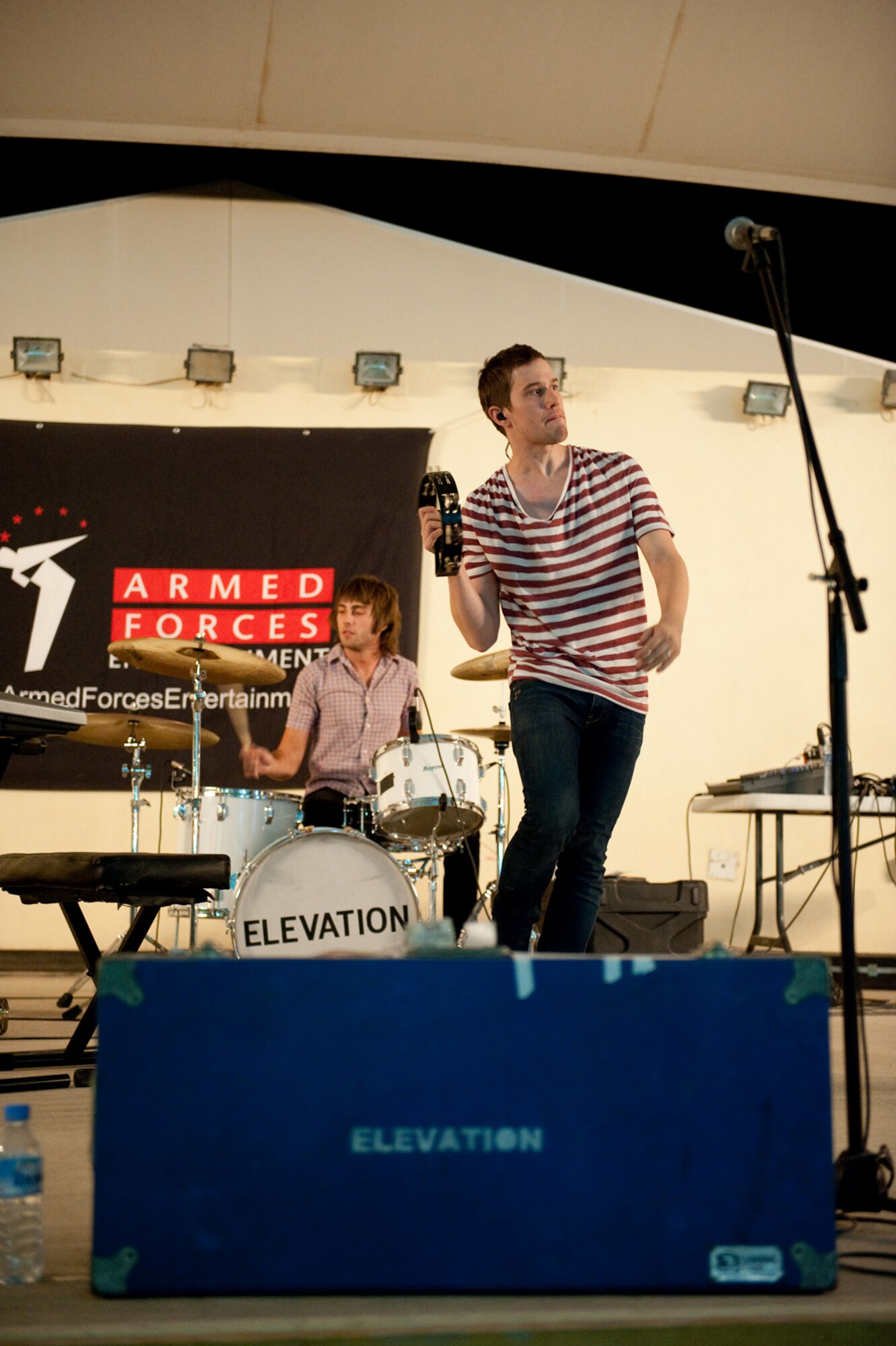 Front, Stephen Bailey and Nathan Smith, members of the Atlanta-based band Elevation, perform in Southwest Asia, July 7,as part of an Armed Forces Entertainment-sponsored event for deployed U.S. and Coalition forces. (U.S. Air Force photo/Staff Sgt. Robert Barney)