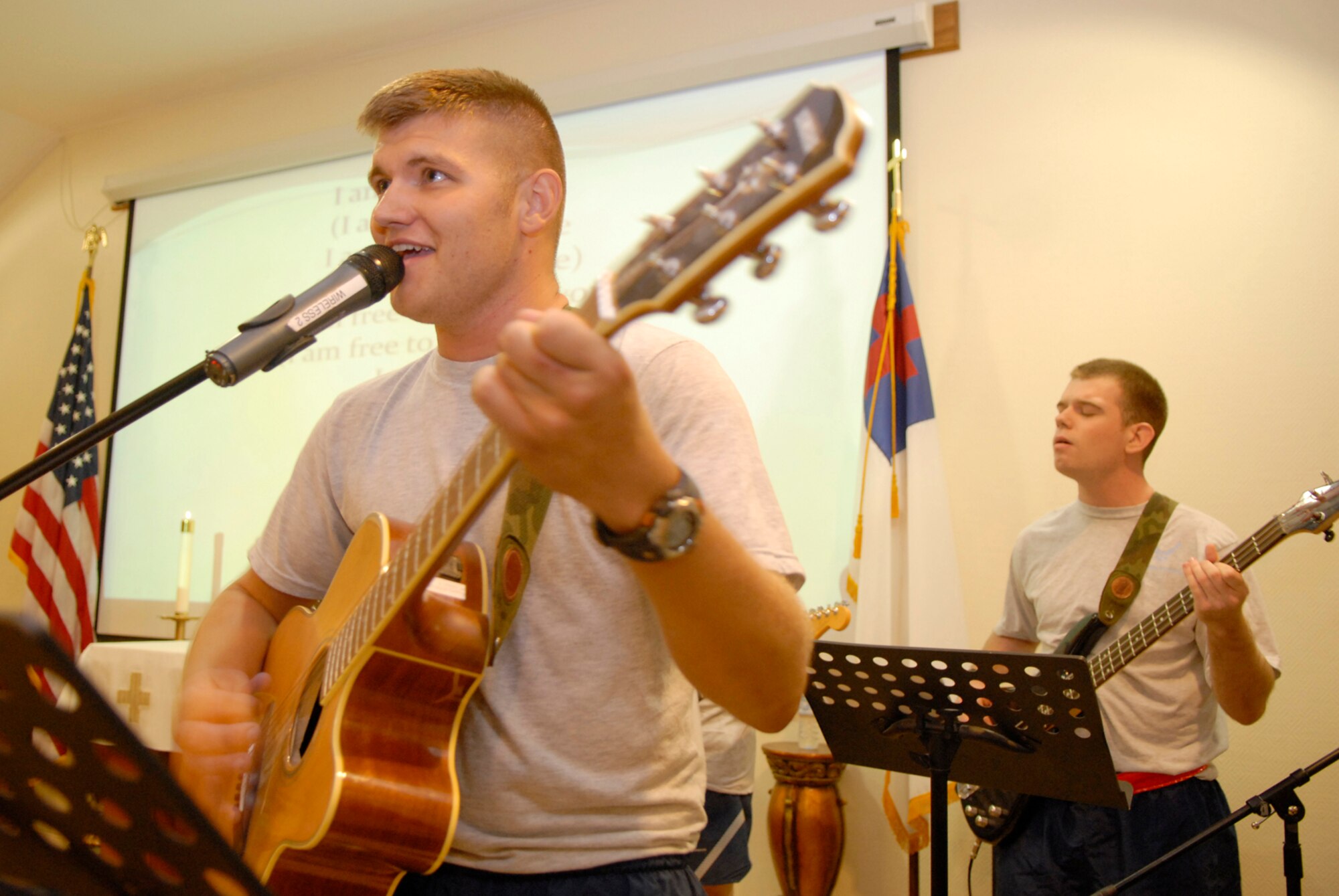 Left, Senior Airman Timothy Bradford and the First Light Band perform at the Victory Chapel Christian Concert, July 5, in Southwest Asia. Servicemembers from all different Christian faiths came to enjoy a night of worship with song and praise.  Airman Bradford hails from Burleson, Texas and is deployed from Dyess Air Force Base, Texas, in support of Operations Iraqi Freedom, Enduring Freedom, and Combined Joint Task Force - Horn of Africa. (US Air Force photo/Senior Airman Andrew Satran)
