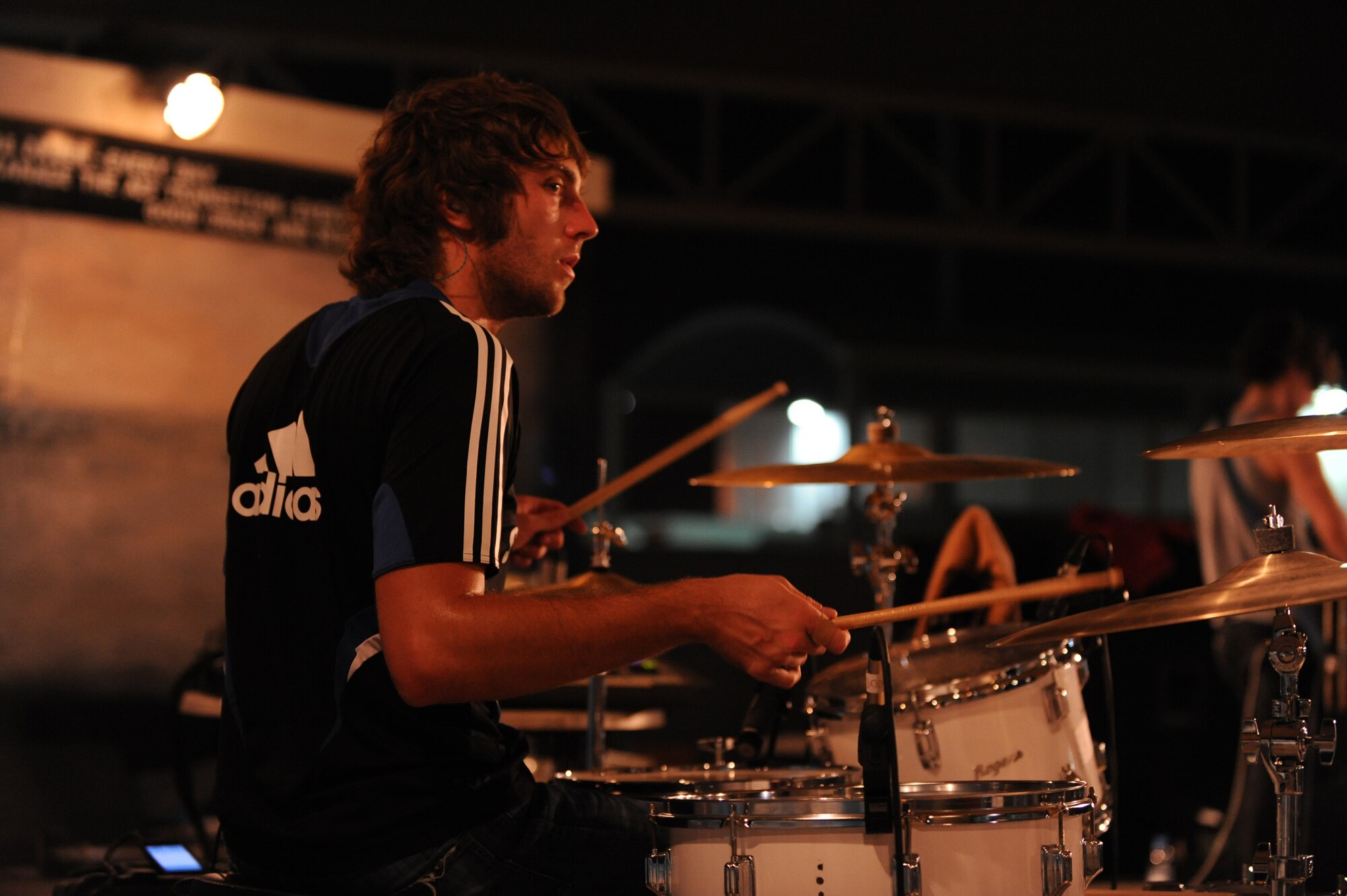 SOUTHWEST ASIA - Stephen Bailey, the drummer for "Elevation," rocks out for Airmen and Soldiers of the 380th Air Expeditionary Wing, July 10 in Southwest Asia. The band performed at several locations throughout Southwest Asia as part of an Armed Forces Entertainment tour. (U.S. Air Force photo by Senior Airman Brian J. Ellis)