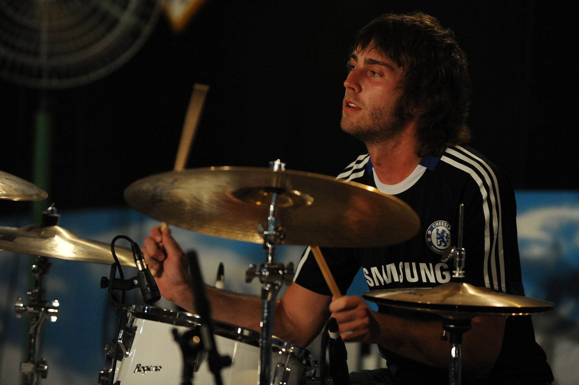 SOUTHWEST ASIA - Stephen Bailey, the drummer for "Elevation," rocks out for Airmen and Soldiers of the 380th Air Expeditionary Wing, July 10 in Southwest Asia. The band performed at several locations throughout Southwest Asia as part of an Armed Forces Entertainment tour. (U.S. Air Force photo by Senior Airman Brian J. Ellis)