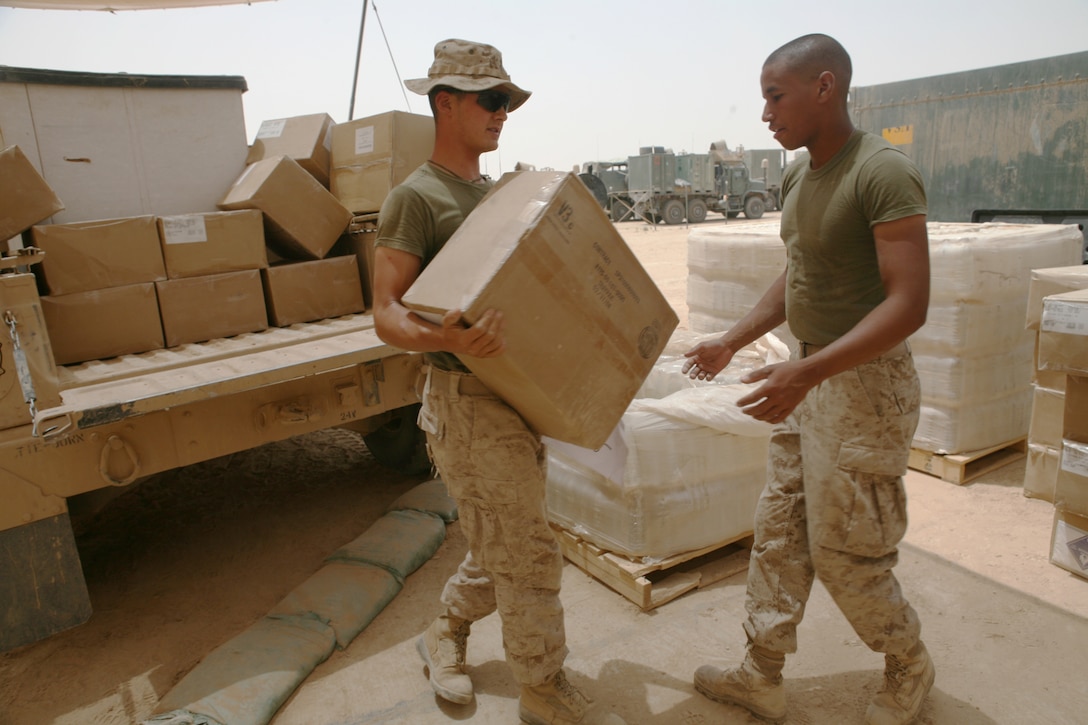 Marines with motor transport section, Headquarters and Service Company, Task Force 3rd Light Armored Reconnaissance Battalion, Regimental Combat Team 8, offload supplies to prepare them for a logistics movement, or logpack, July 11, 2009, at Sahl Sinjar, Iraq.  Logpacks are meant to supply companies operating throughout the battalion area of operations who aren’t able to supply themselves due to mission requirements.